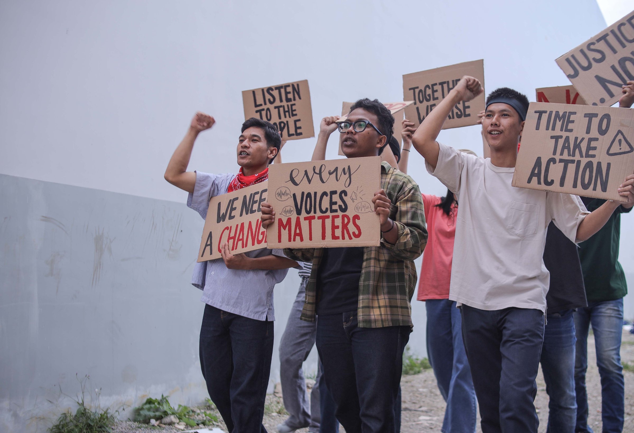 Group Of Young Diverse Protestors Passionately Holds Up Signs With Messages
