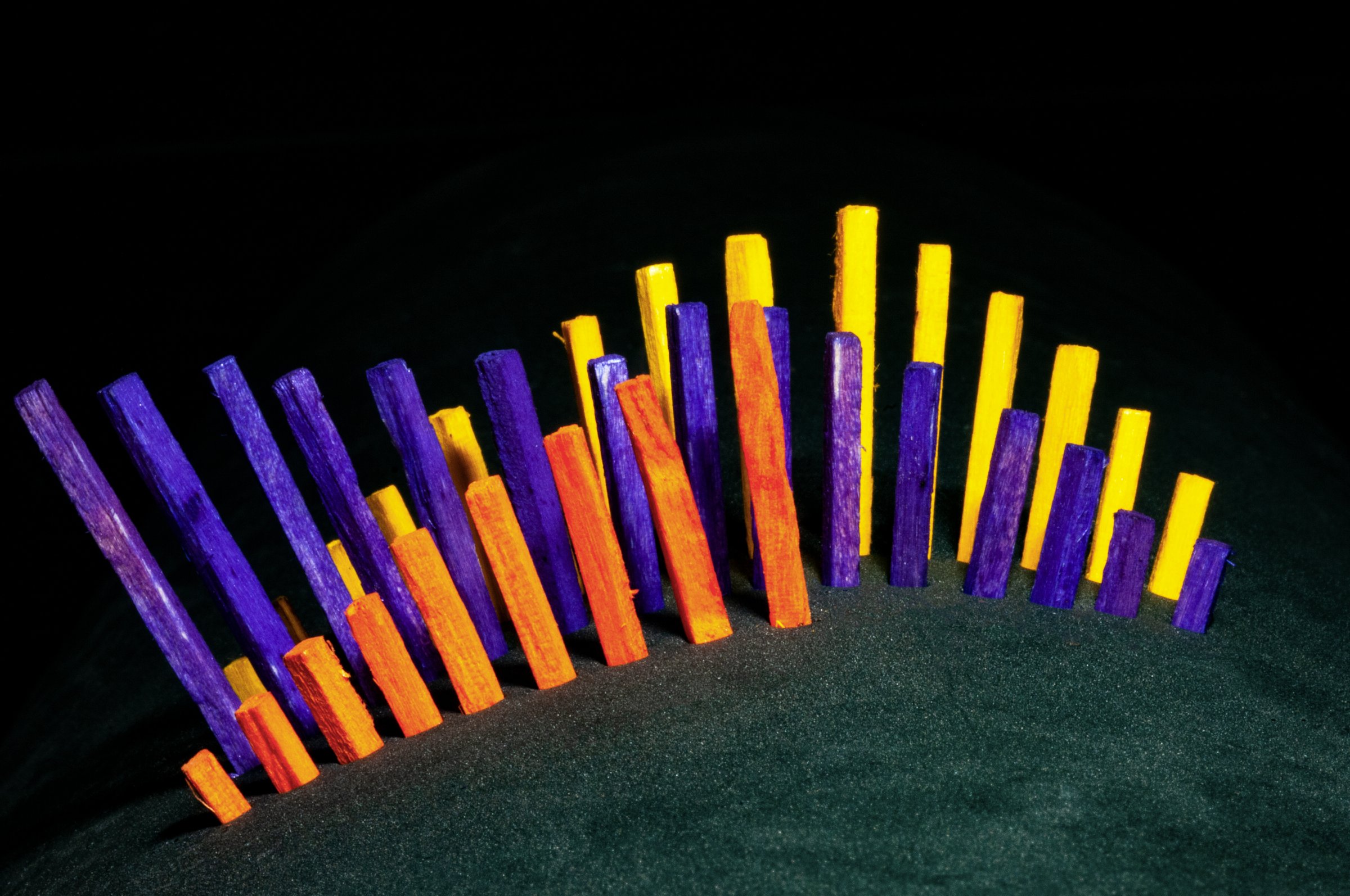 Wooden colored sticks as a business histogram in black background
