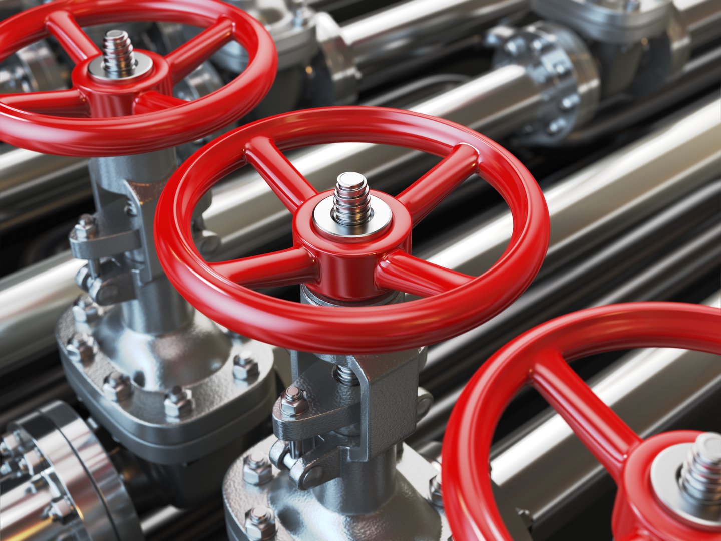 Industrial piping with red valves and brass with blur background