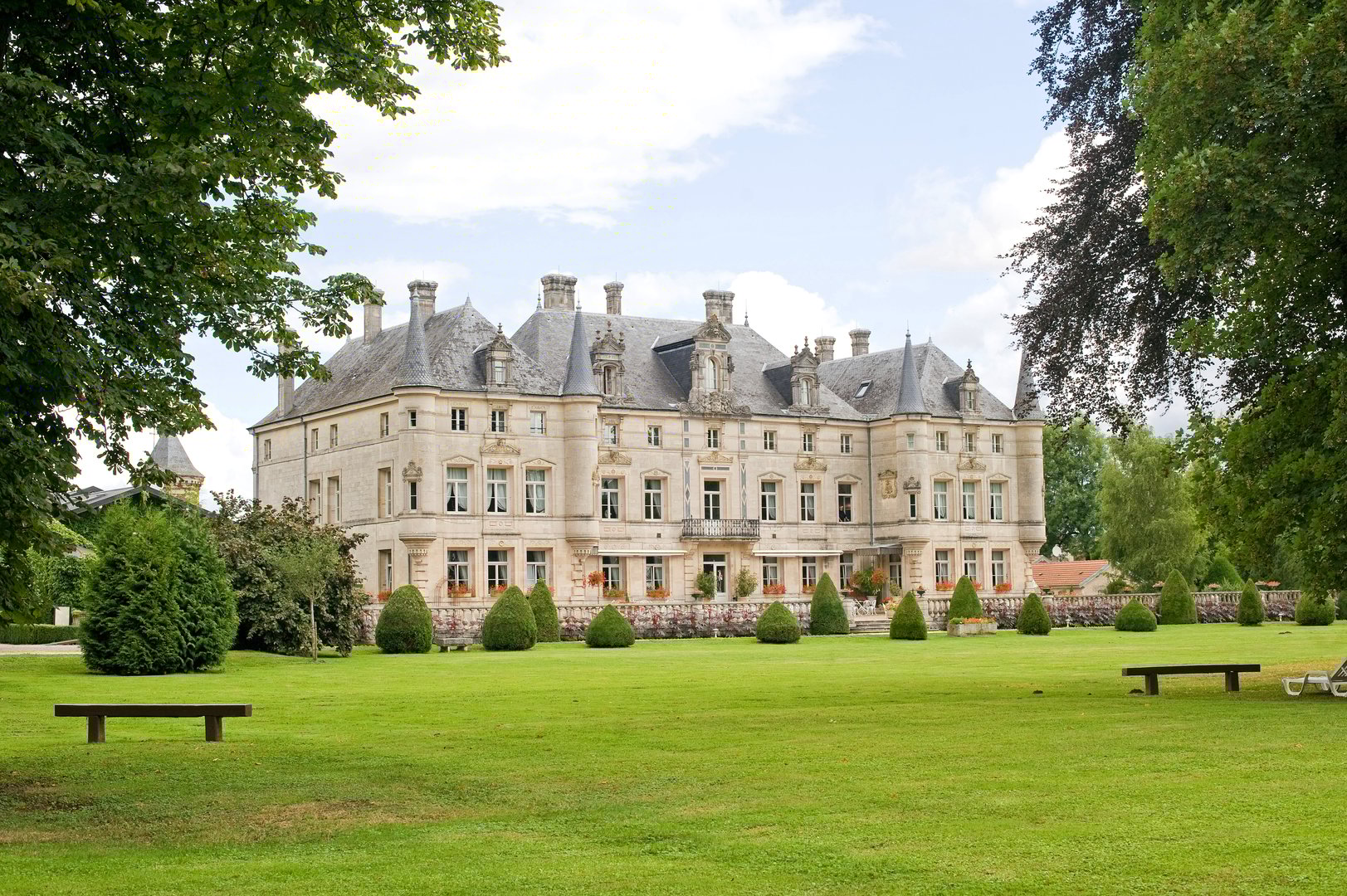 Les Monthairons, France - July 24, 2009: Castle in the Lorraine region, near Verdun, with its park, at summer. Built in 1857, this building is now an exclusive hotel.