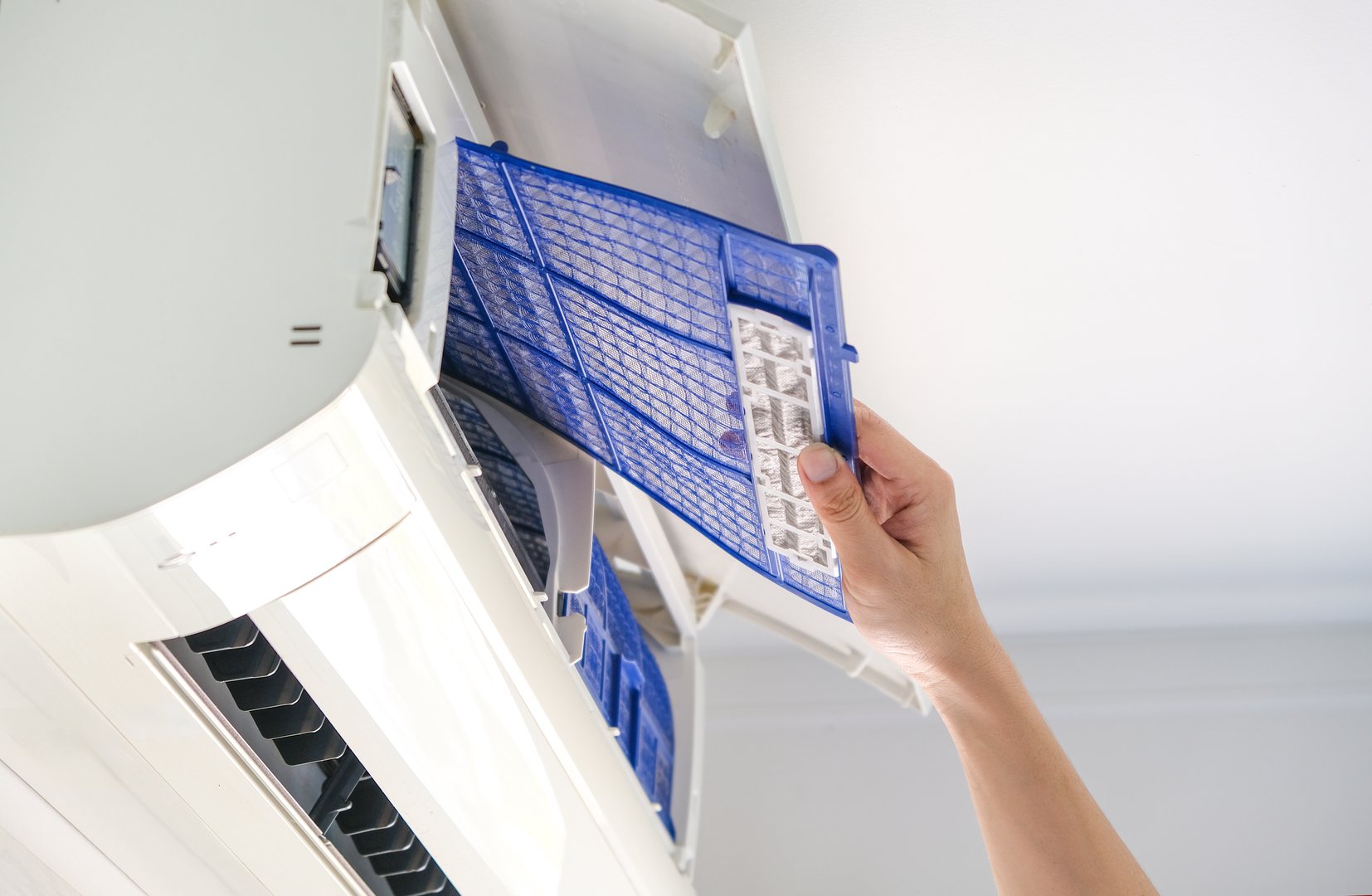 Male repair air conditioner at the room, He is air technician, mechanic, engineer. Maintenance air conditioner myself