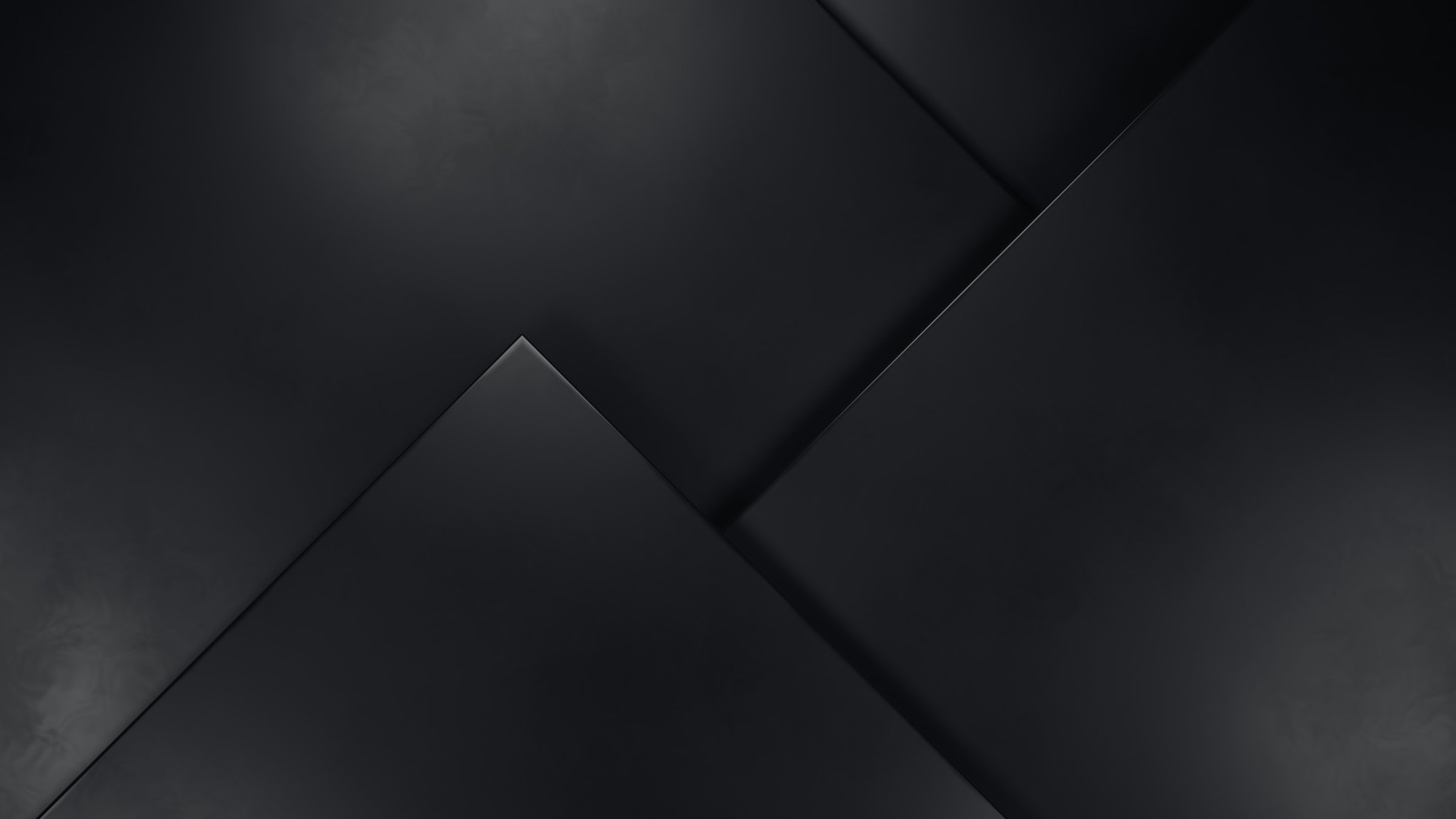 Dark abstract background with overlapping black geometric shapes creating a modern and minimalist design.