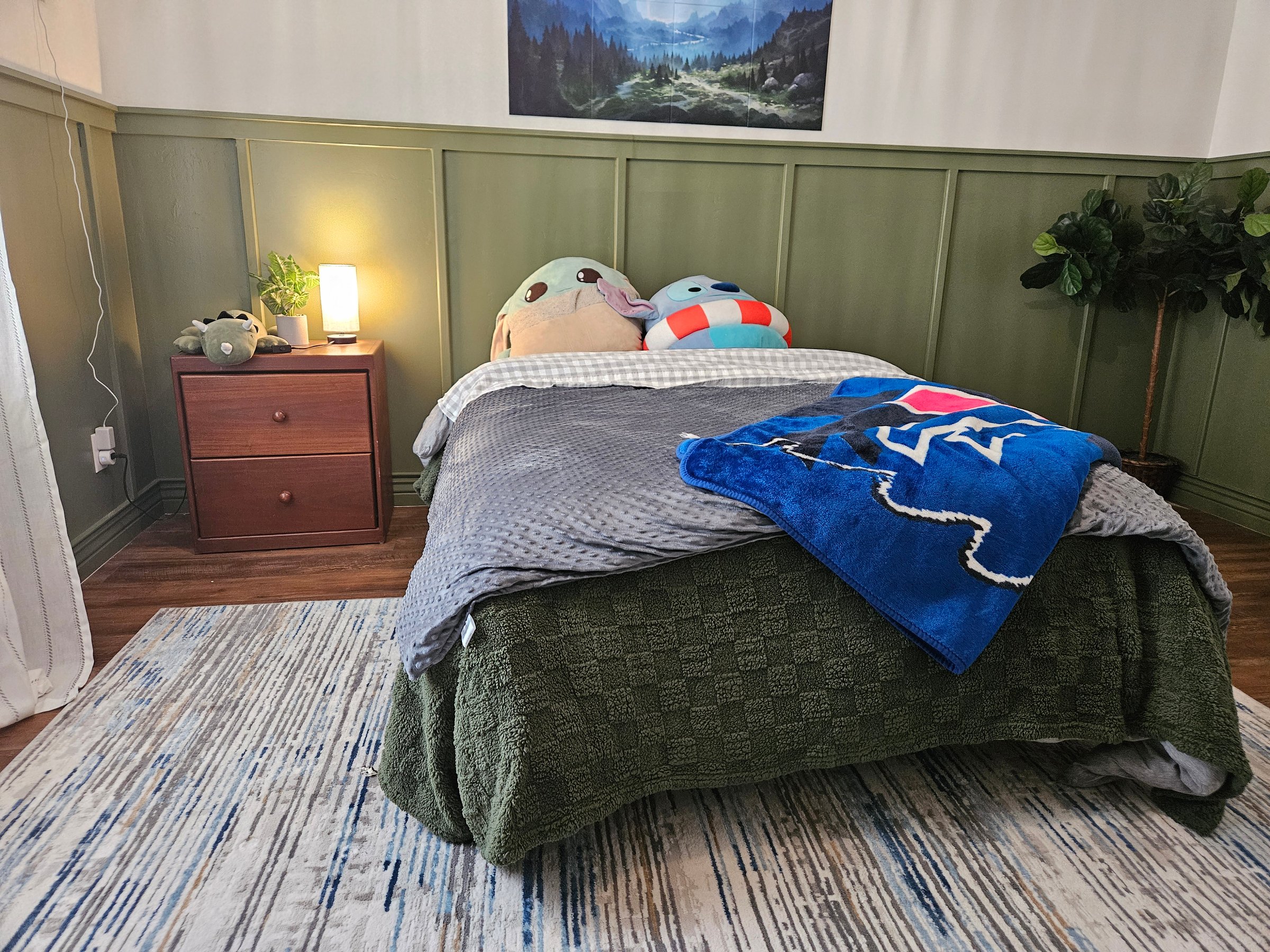 Cozy children's bedroom with biophilic design featuring green board and batten walls