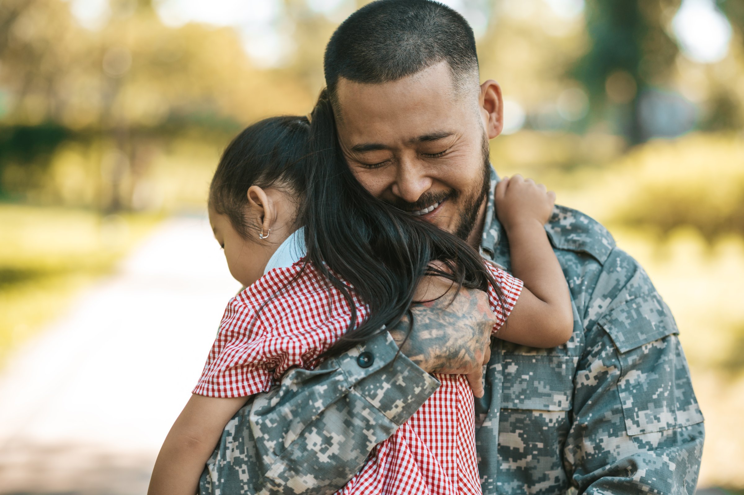 Military dad hugging daughter happy