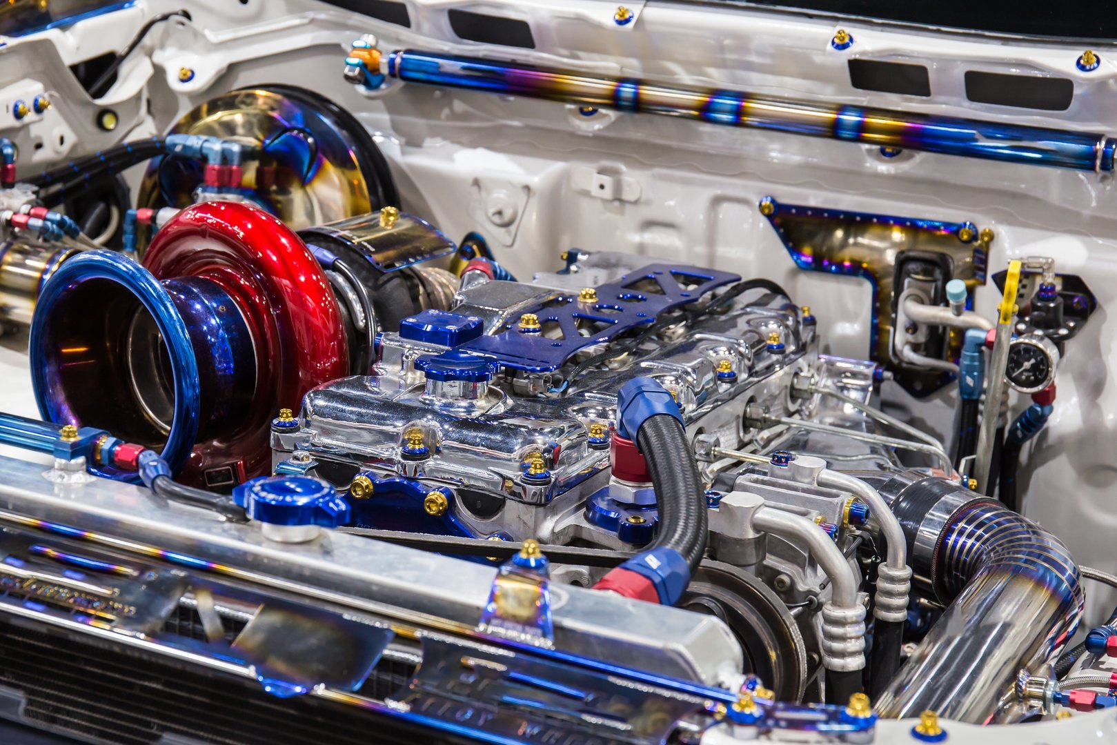 Close up of colorful custom setup of a race truck that has a modified engine and turbo installed.