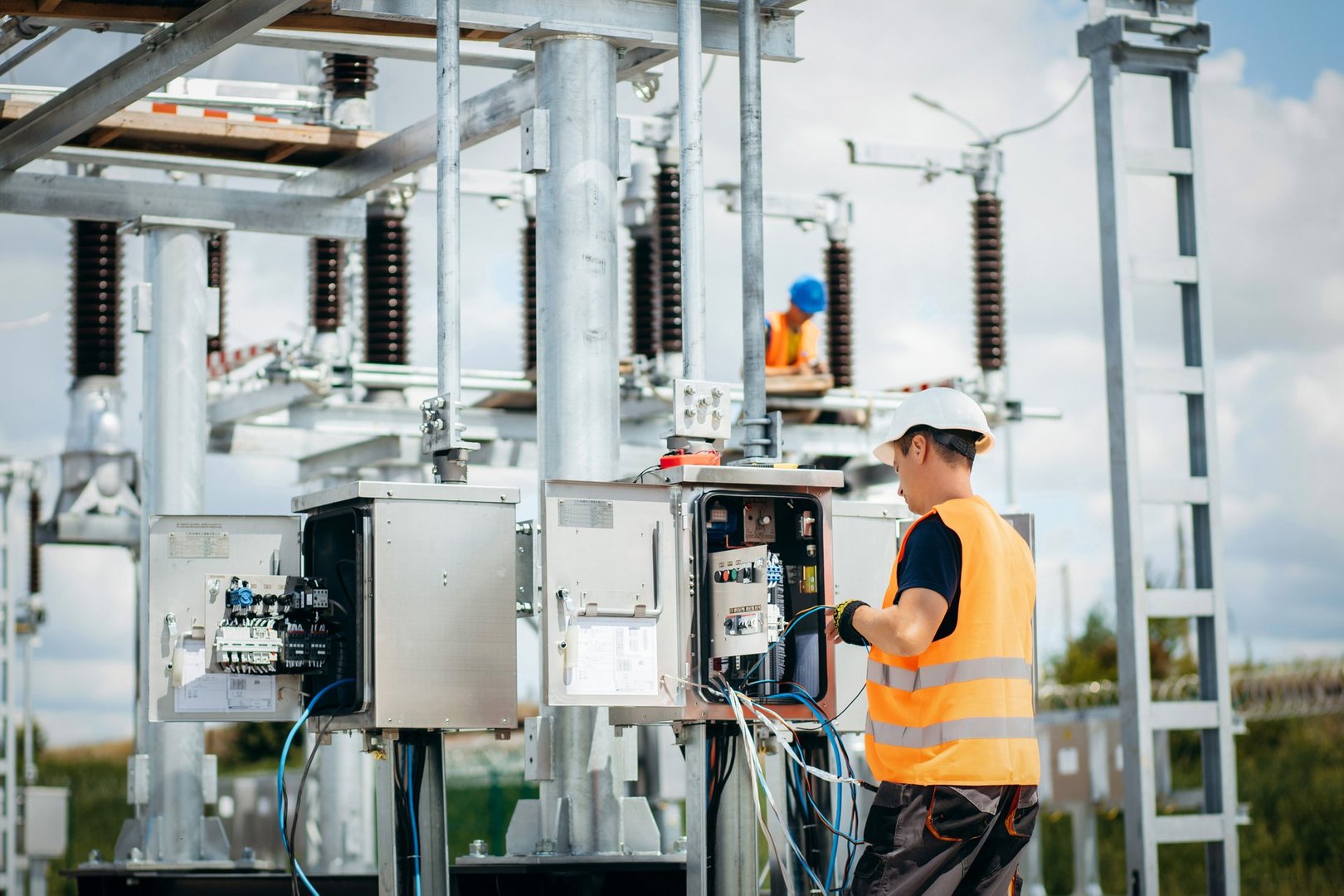 Adult electrical engineer mount the electrical systems at the equipment control cabinet. Installation of modern electrical station