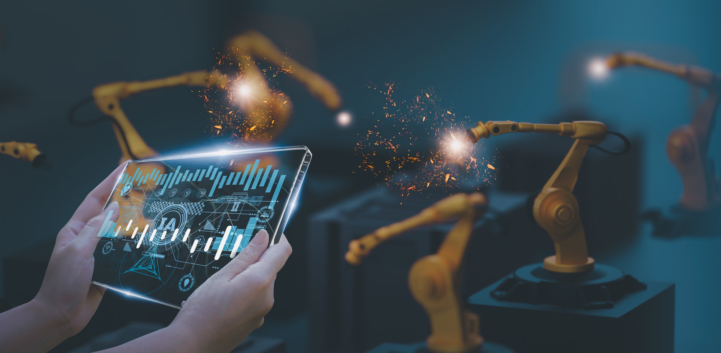 Industry engineer in smart factory using transparent glass tablet to control automated robotic arm with AI and 5G network, machine learning technology, business innovation in industry 4.0 era