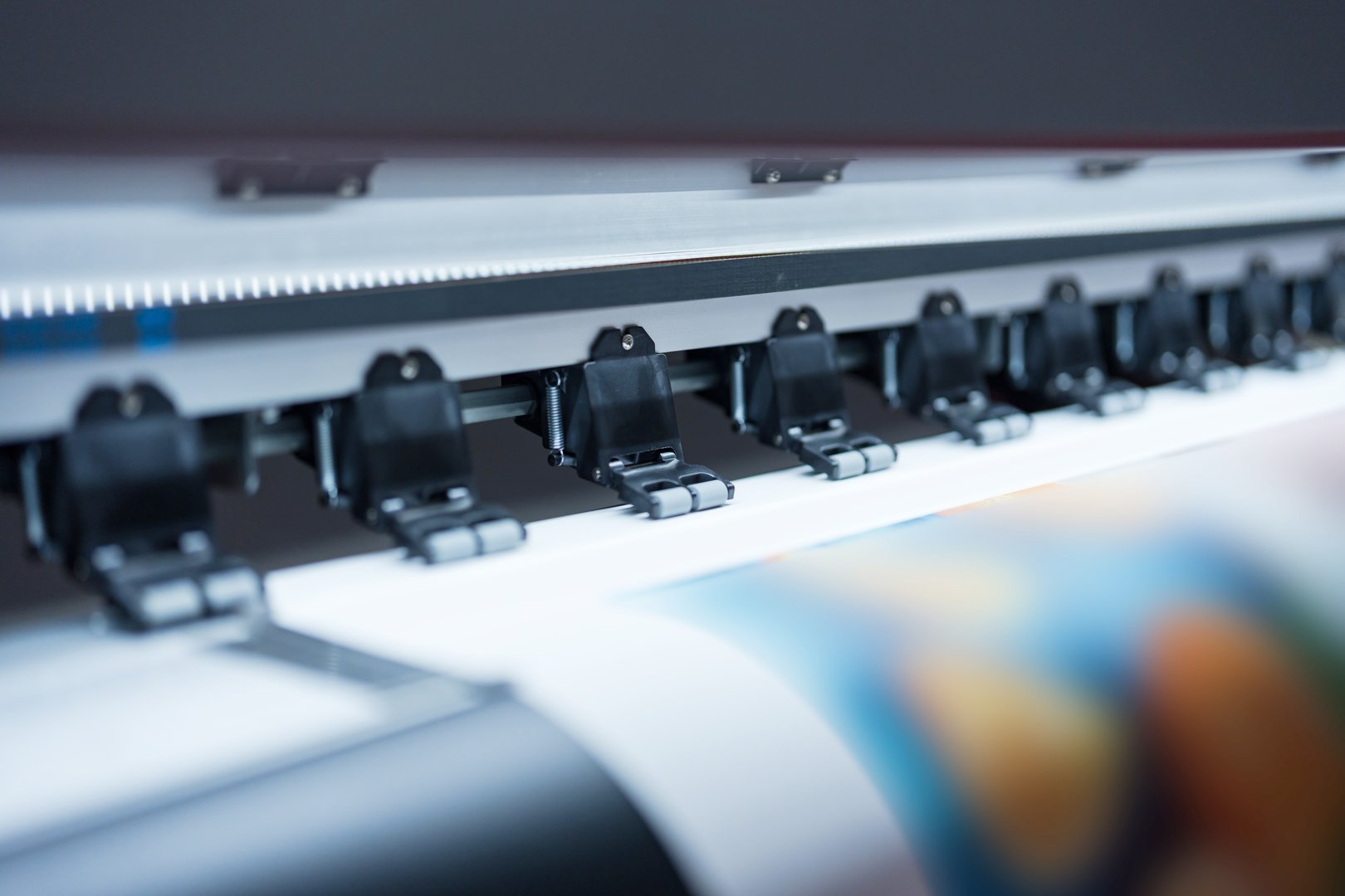 Close-up of large format printer heads in action, Detailed view of modern large format printer heads working on white media