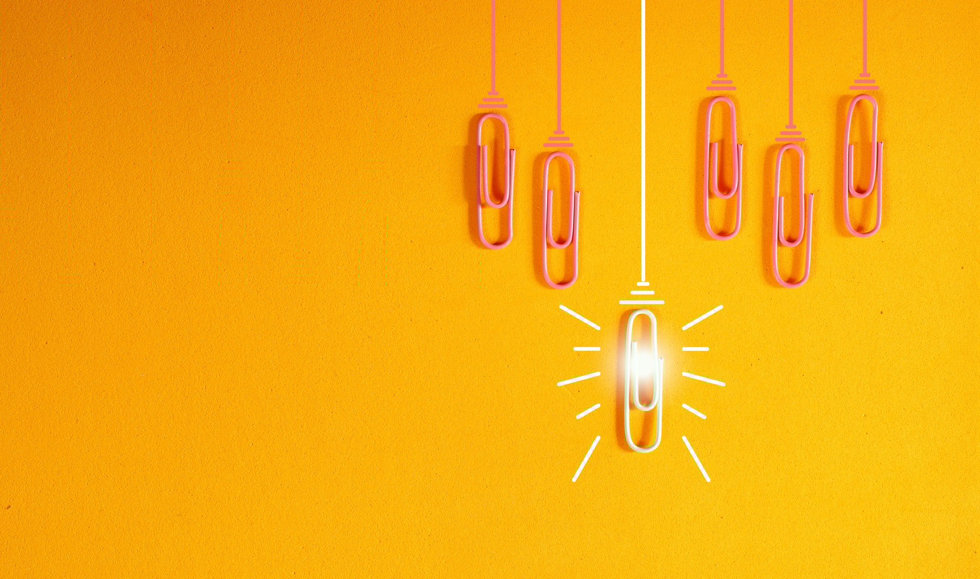innovation concept with paperclip,thinking,creativity,light bulb on orange background,business and society concept. Large free copy space.