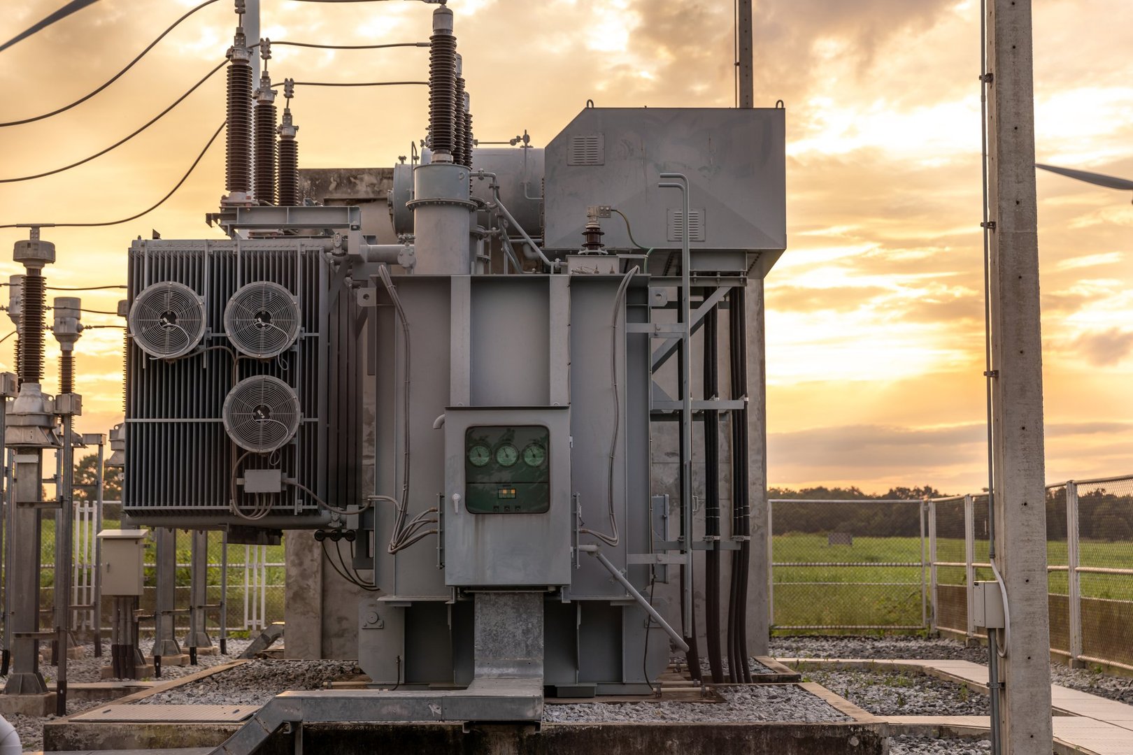 The transformer on a concrete pole. Three-phase transformers and rafts on rails for industrial plants. Transformer on concrete column beams.