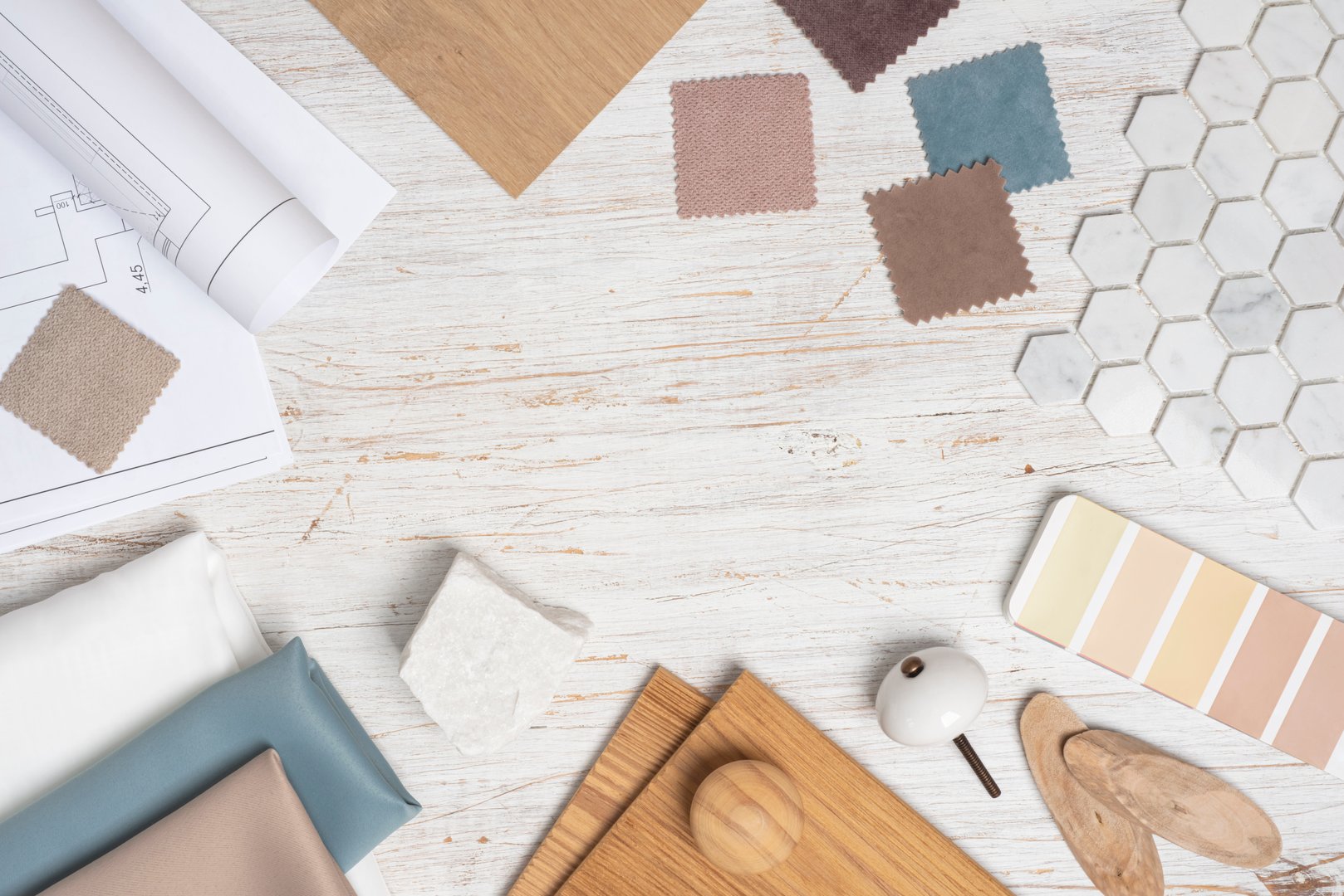 Top view of creative desk with modern house material samples and copy space