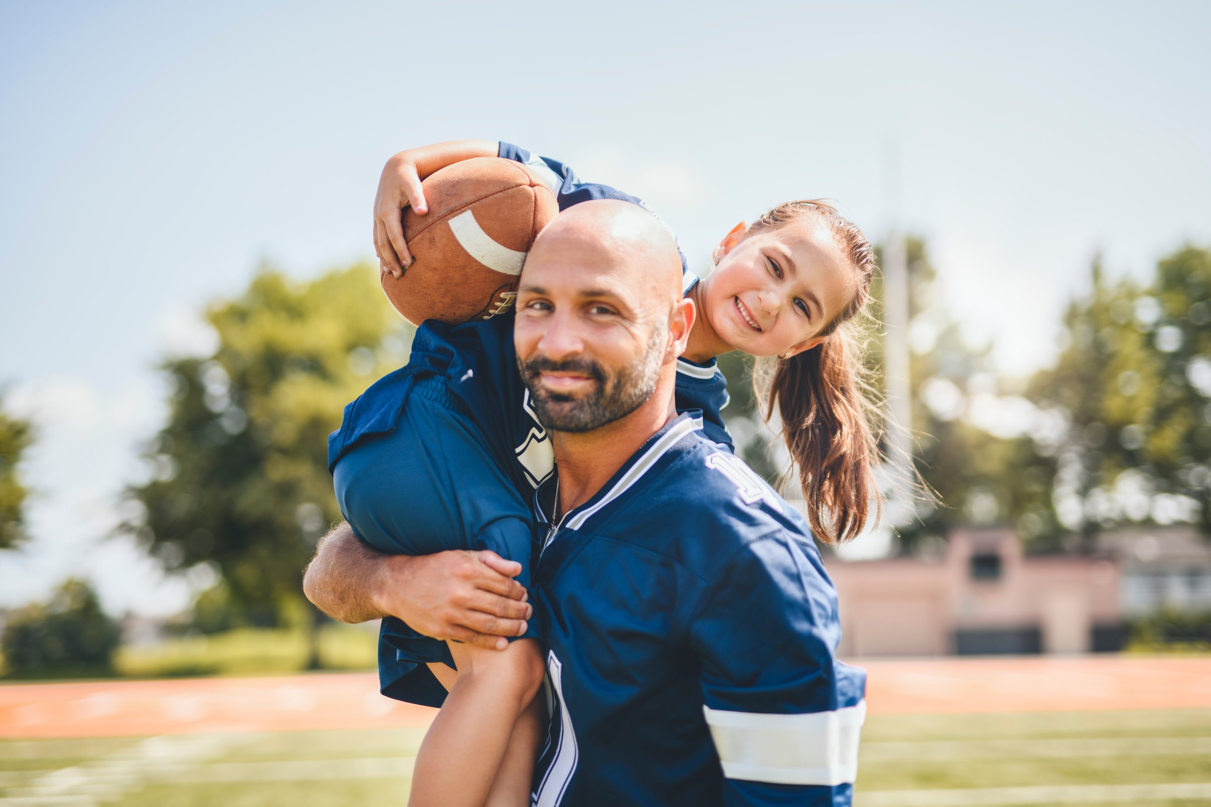 The football, sport with a dad and daughter training on a court outside for leisure fitness and fun