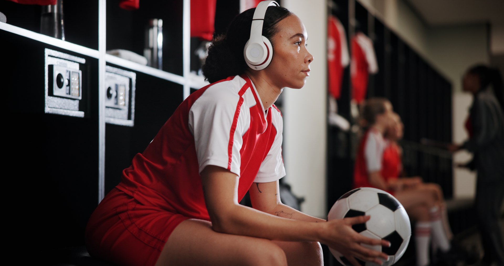Sports, locker room and woman with headphones and ball for music, audio and radio for training. Relax, soccer and person streaming for exercise, practice and workout for match, game and tournament