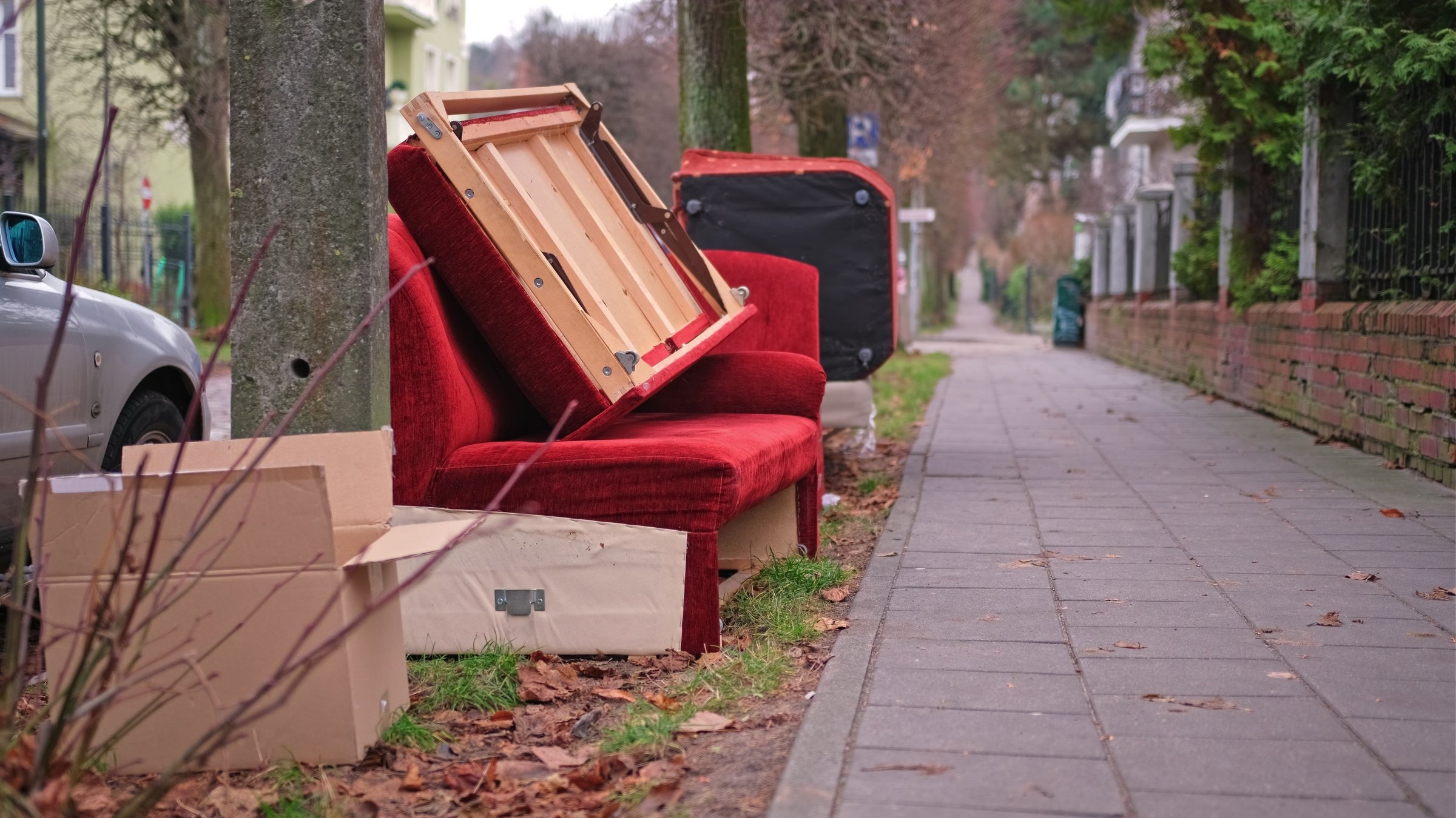 Old Unwanted Furniture Couch Dumped on Sidewalk on Bulk Garbage Collection Day for Curbside Pickup by City Cleaning Services