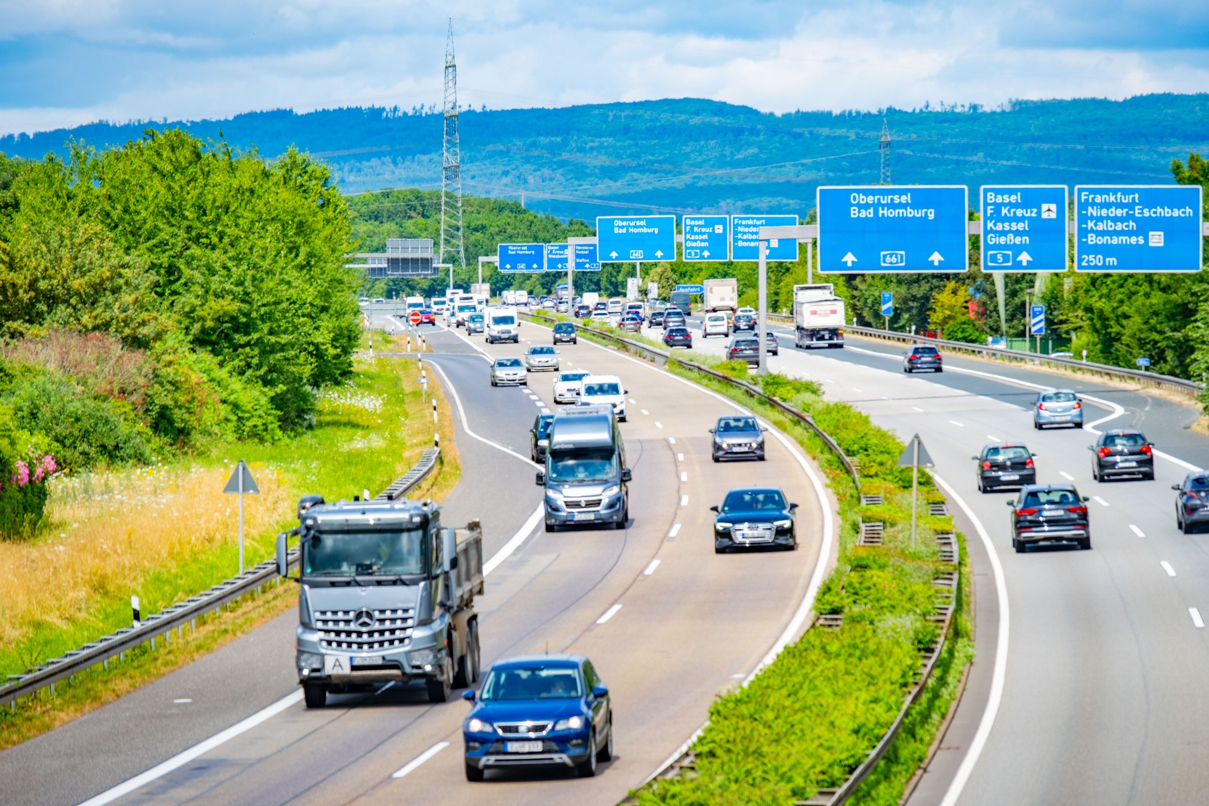 Busy German autobahn with cars and trucks heading to Frankfurt showing efficient European transport system, expressway, Modern multi-lane highway infrastructure in Frankfurt, Germany - July 11, 2025