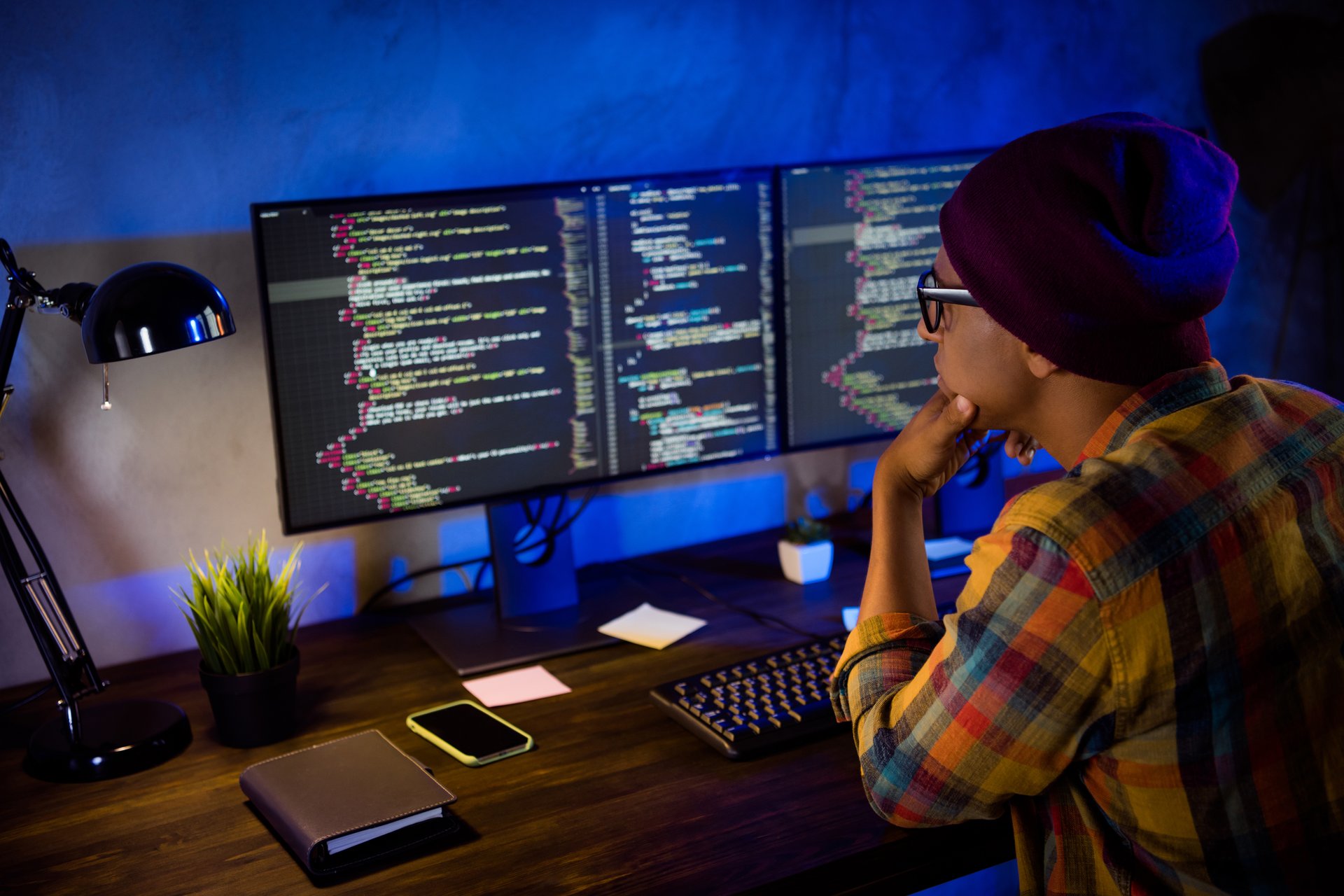 Profile photo of intelligent web designer sitting chair operating pc working overtime night office indoors.