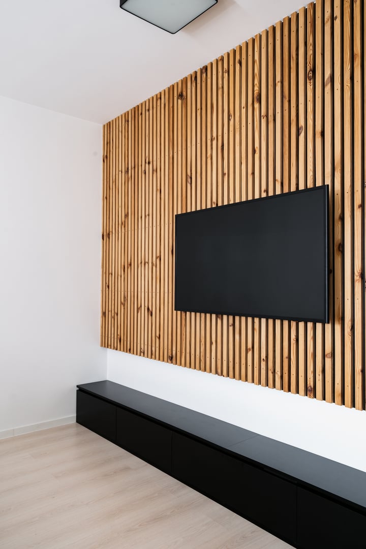 Home cinema, smart tv. Flat screen television is mounted on wall in a contemporary living room. Interior complements the wooden design and entertainment multimedia technology, vertical shot