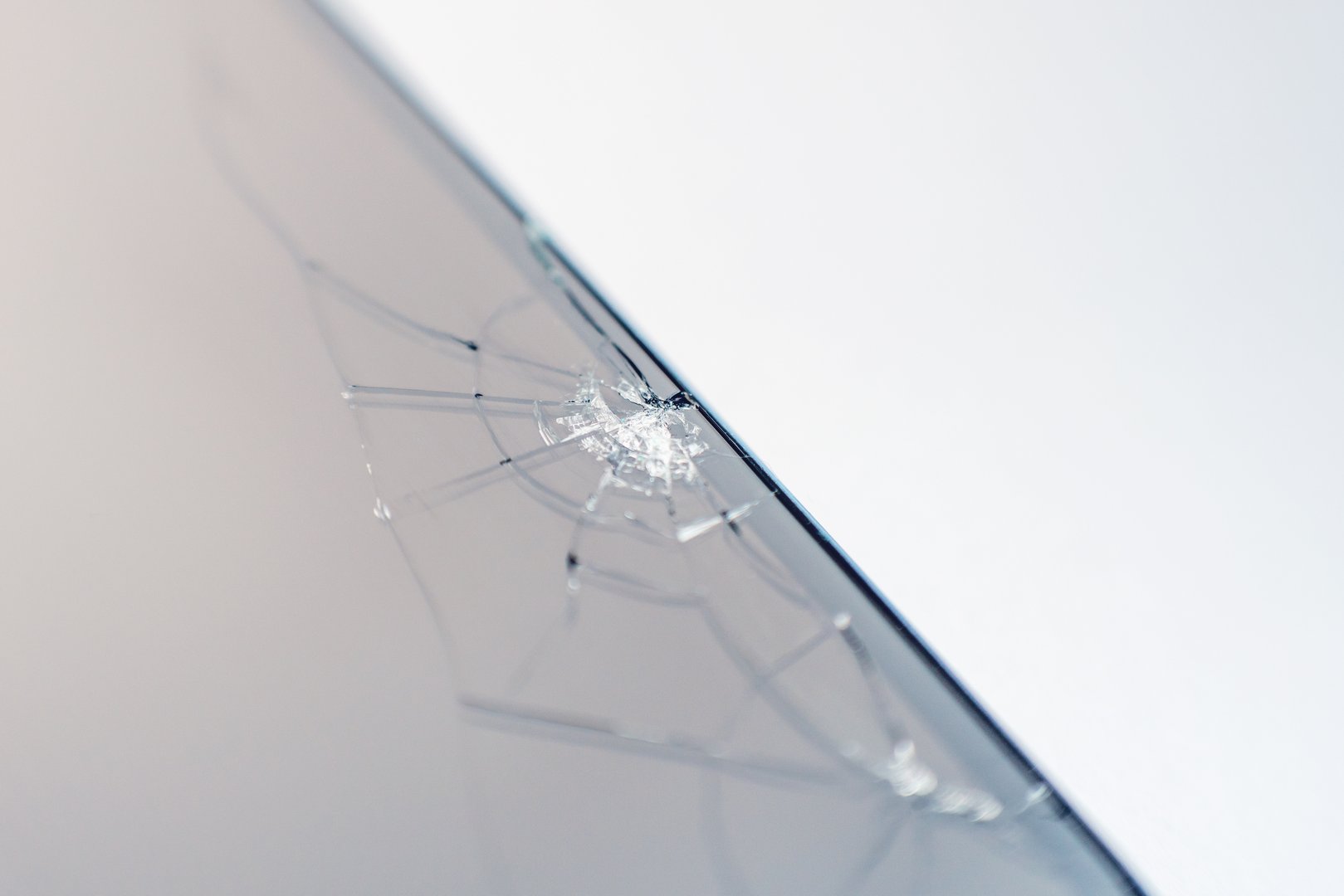 Cracks on the screen of a broken phone.