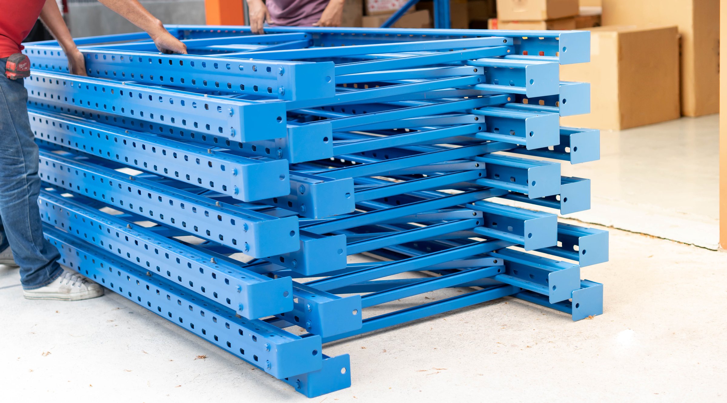 Male hand holding pile of the metal rack prepare for assemble to metal rack install in warehouse or storehouse and metal shelf for  put the product .