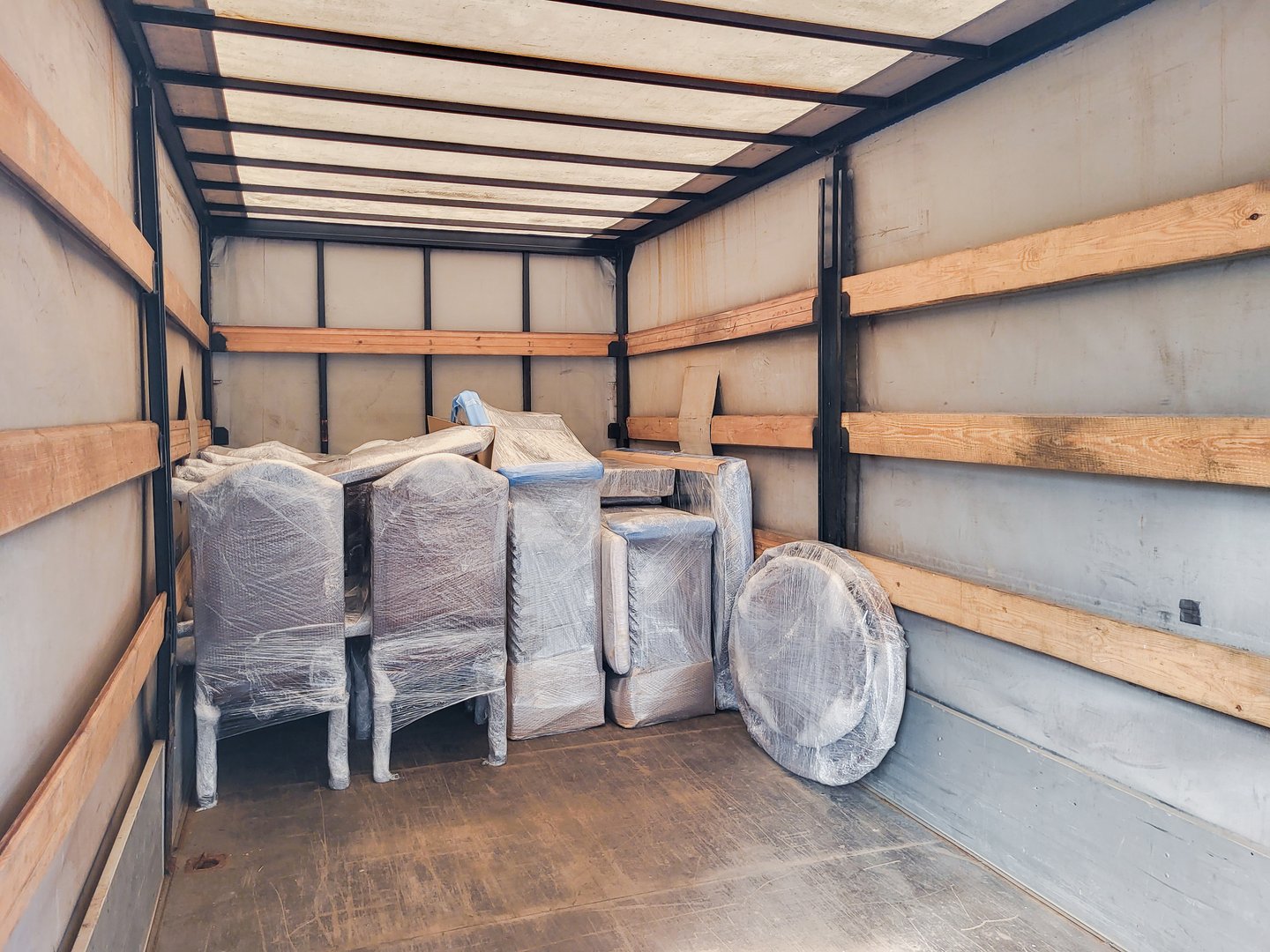 Packed furniture and boxes prepared for moving inside the truck cargo