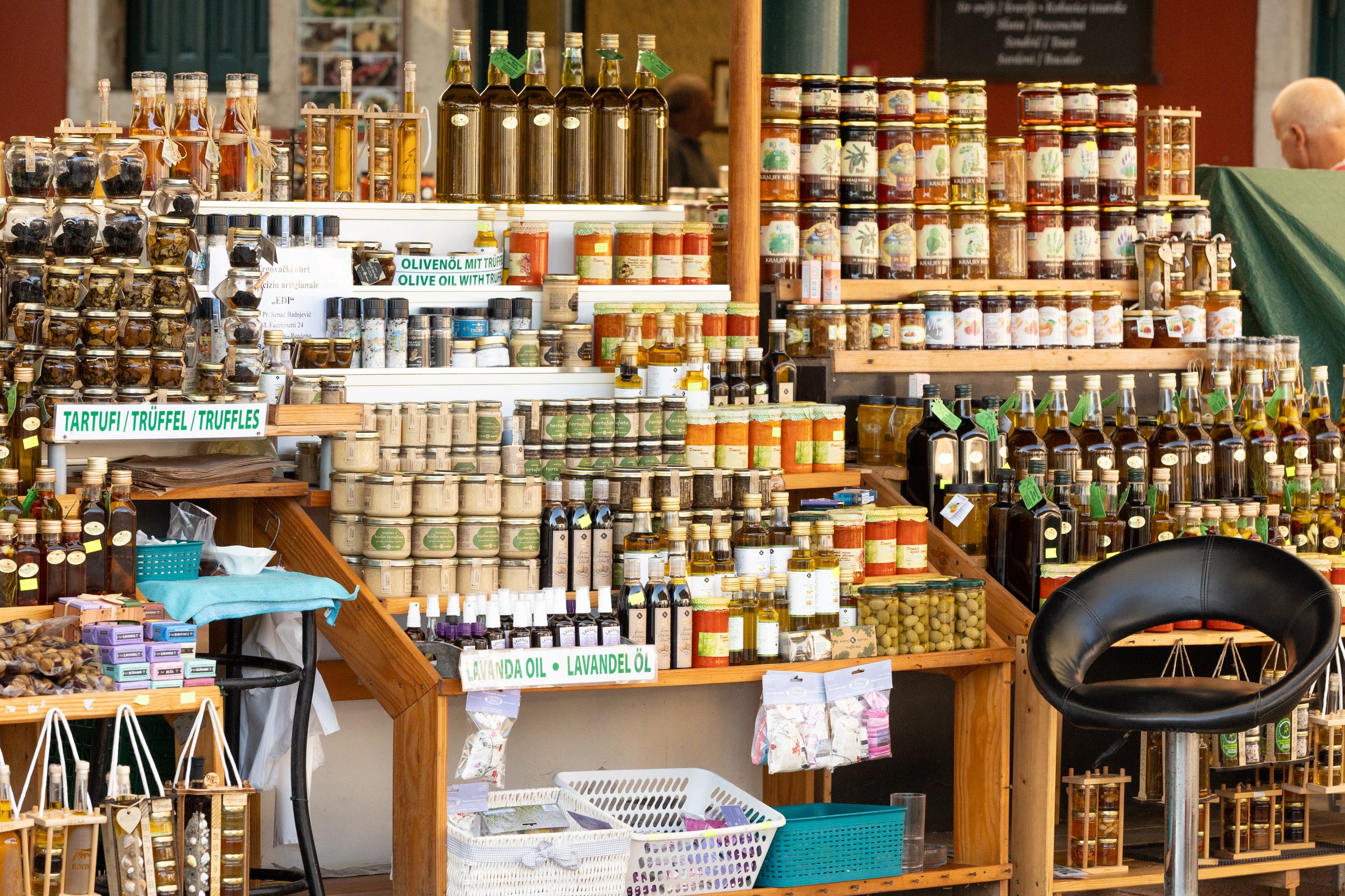 Croatia, Rovinj - September 23, 2024: Shelves with a rich assortment of honey, truffles and olive oil on the market stall in the town
