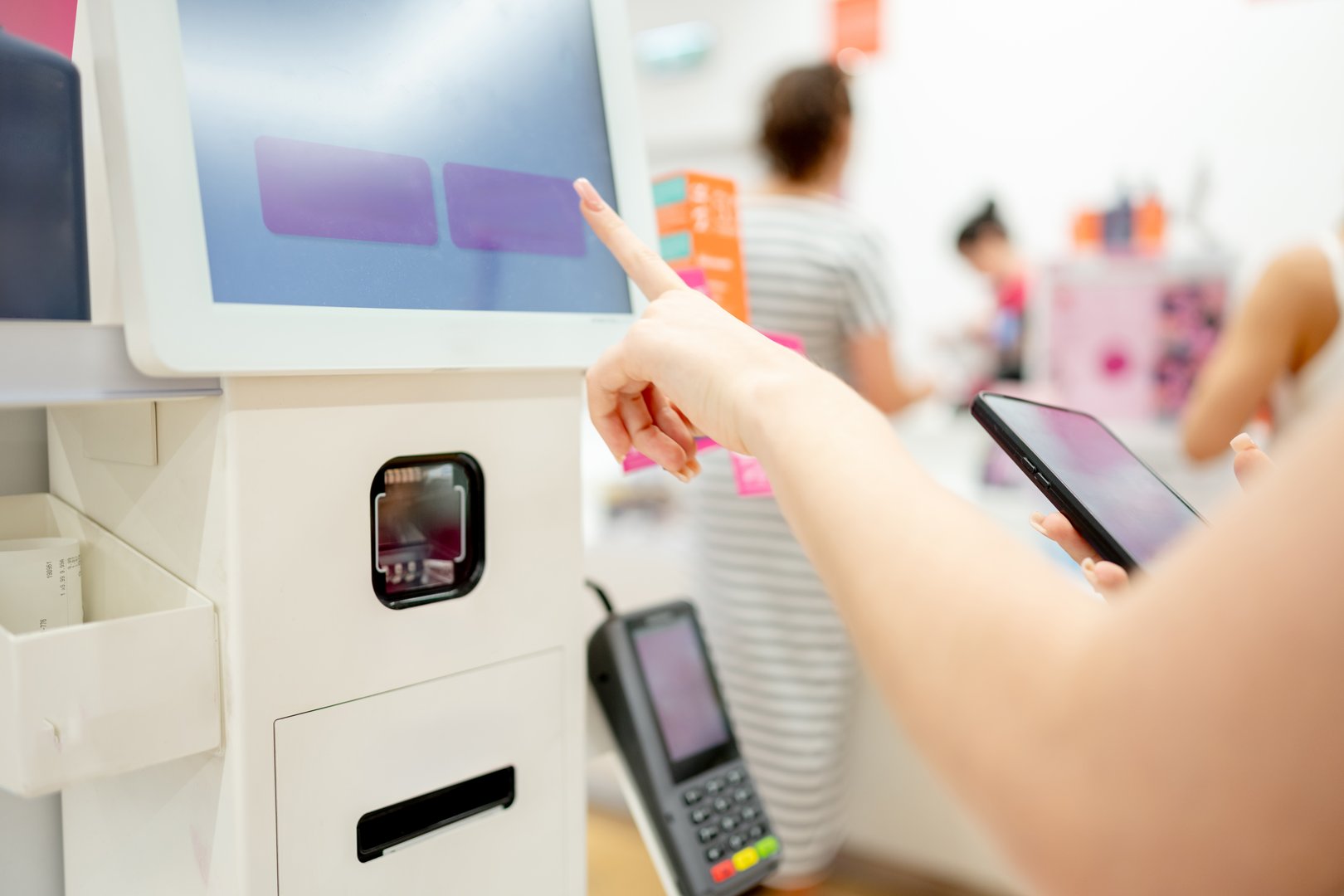 Girl Pays For Purchase At Self-Service Checkout, Close-Up Of Hands