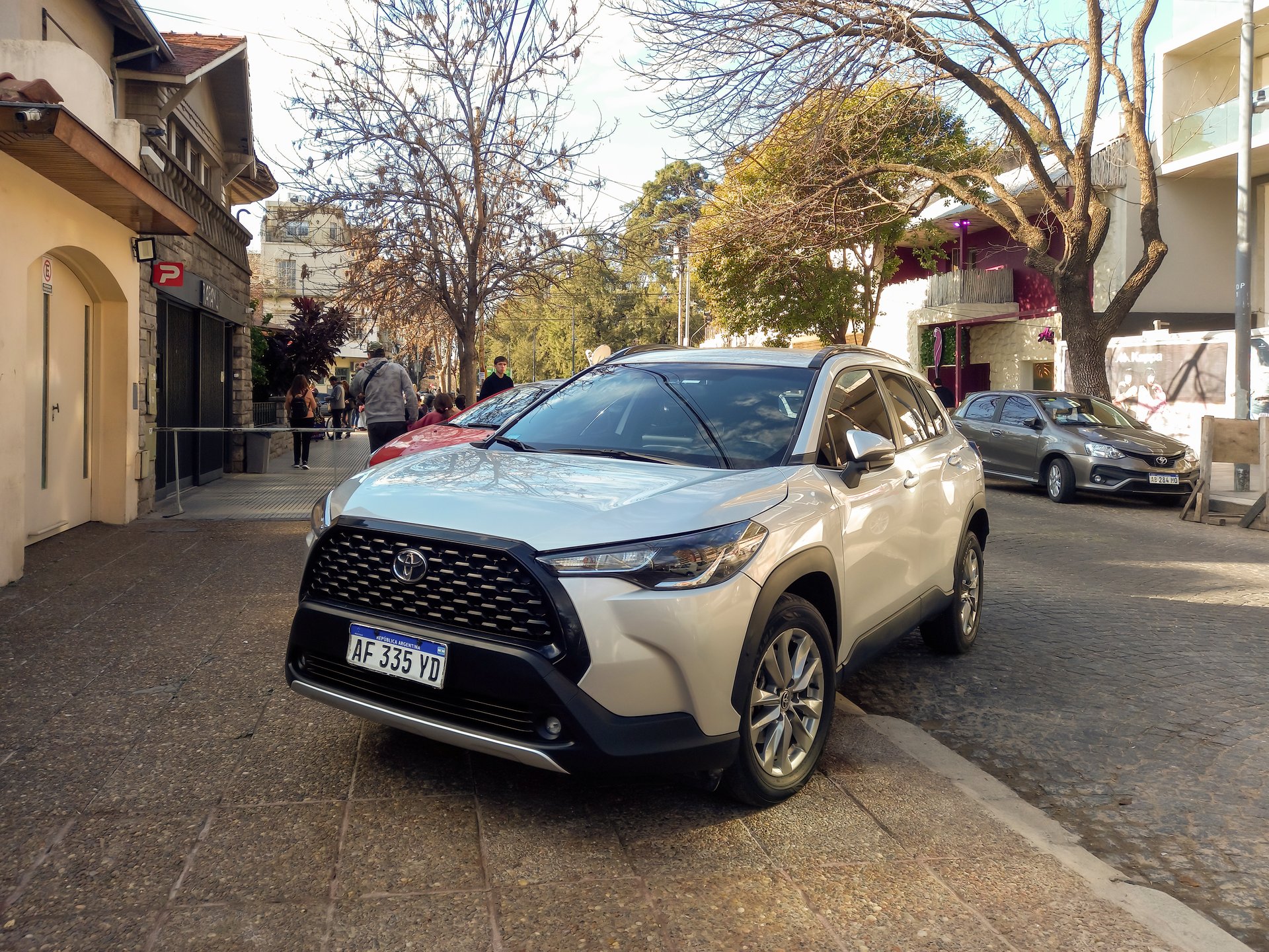 Buenos Aires, Argentina - Jul 9, 2025: Modern gray shiny 2020s Toyota Corolla Cross SUV car on the sidewalk in a city street.