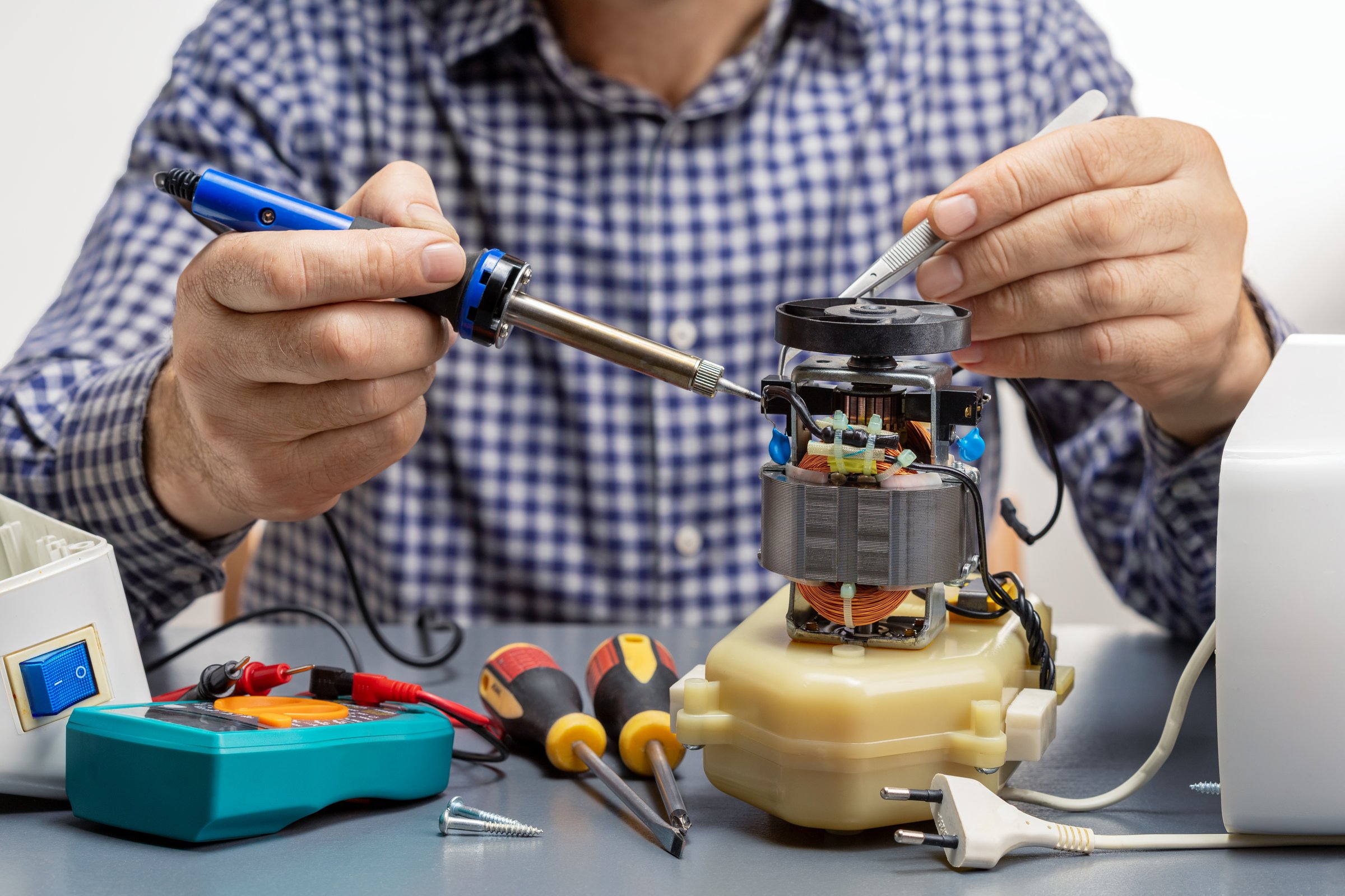 Technician repairing household equipment