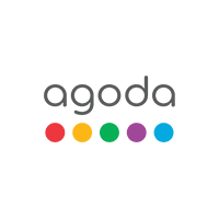 Agoda logo featuring lowercase letters in gray with a row of colorful dots below: red, yellow, green, purple, and blue.