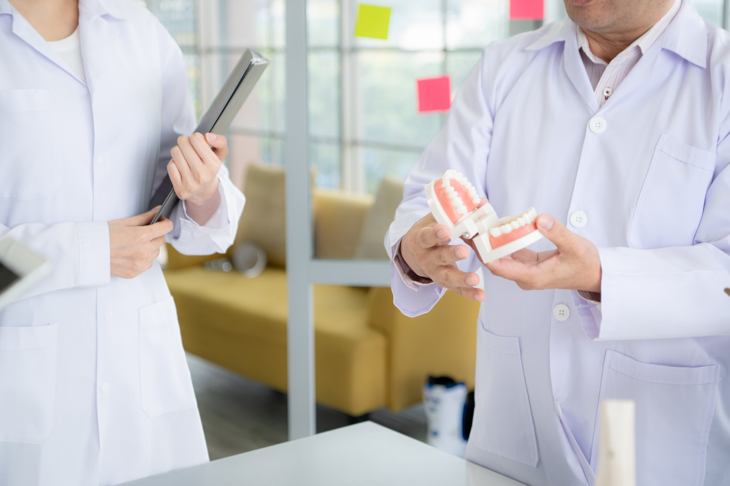 A medical professor is lecturing on a case study related to oral and dental treatment to medical students