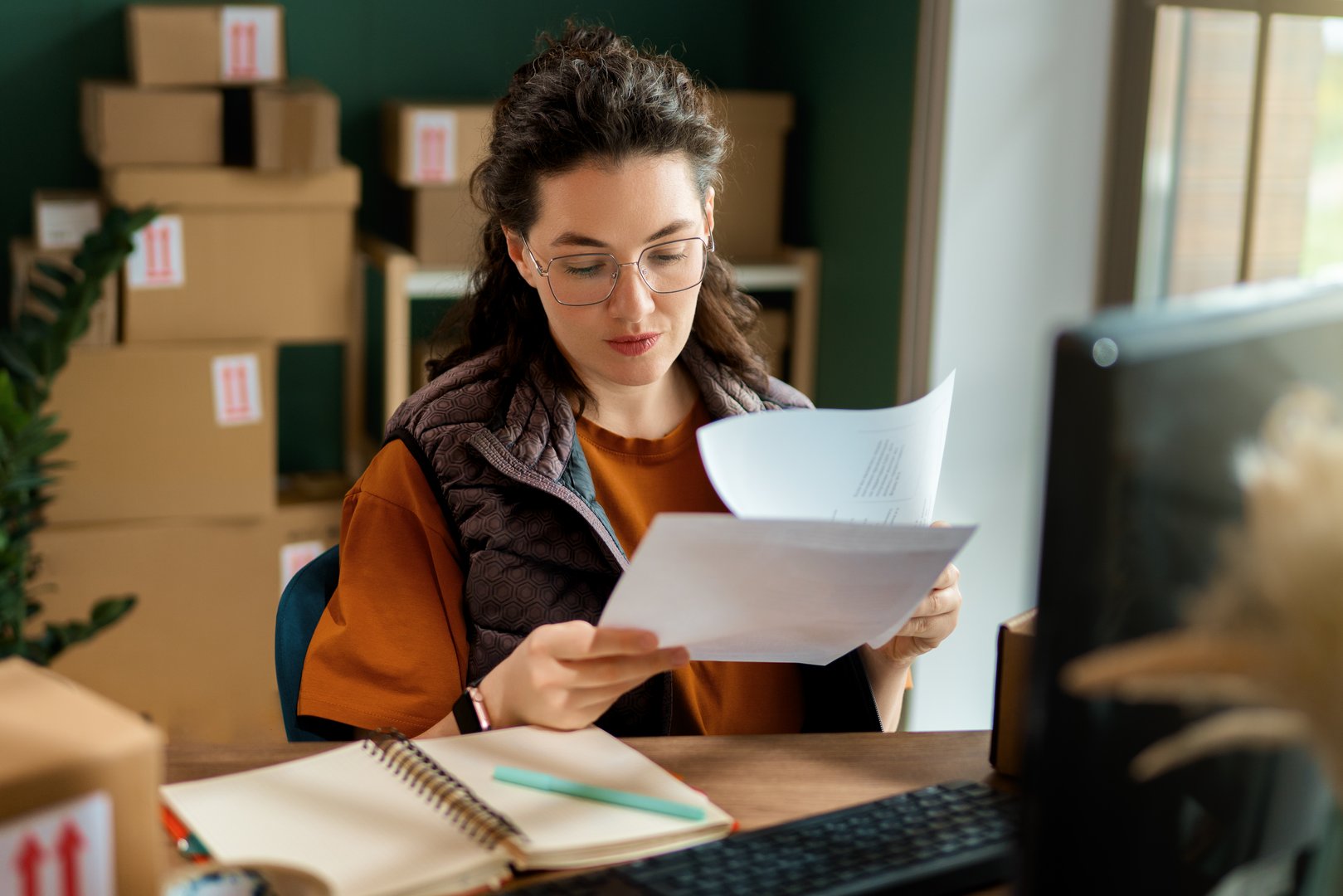 Female inventory manager checking stock. Woman working in a warehouse.