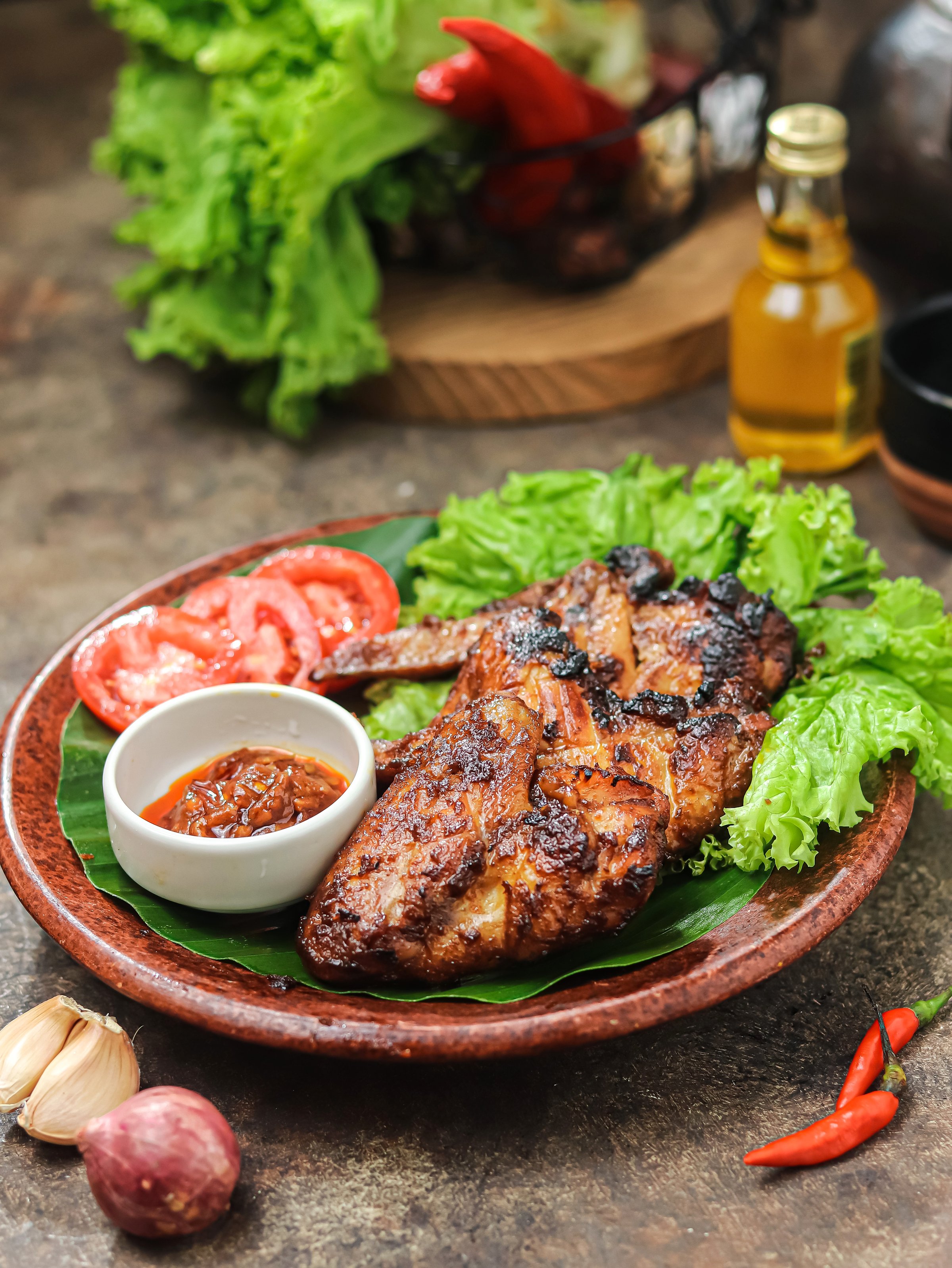 Sayap ayam bakar kecap, or soy sauce-grilled chicken wings. Grilled chicken wings with various spices and soy sauce. It tastes spicy, sweet, and delicious. Isolated