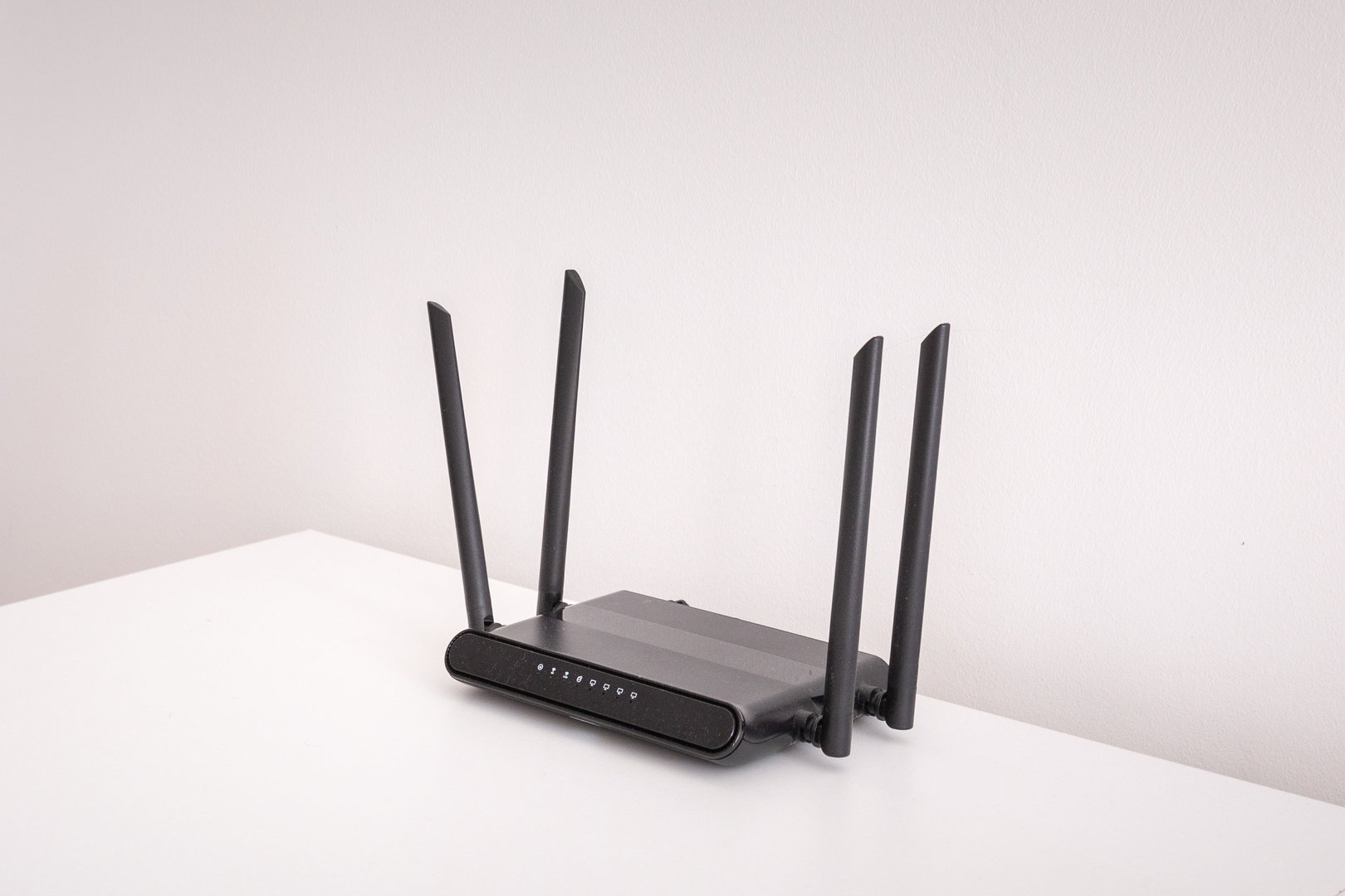 black wifi router on white table indoors. wireless connection concept