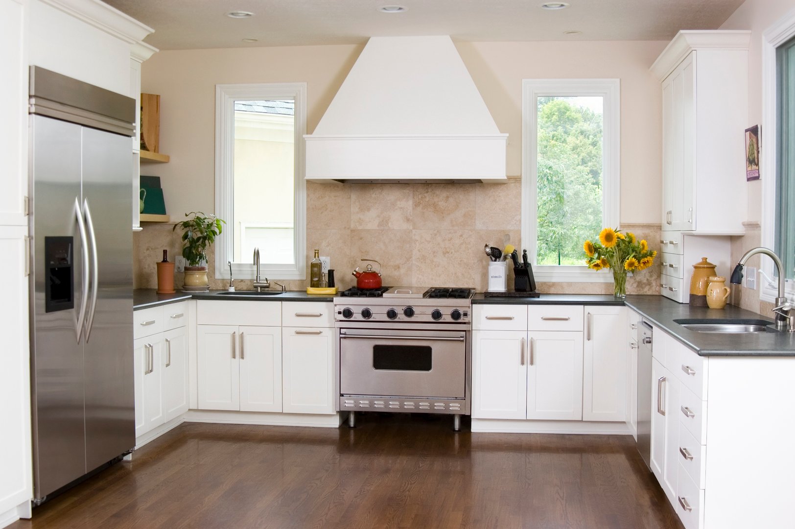 A beautiful, custom kitchen with hardwood floors, stainless steel appliances and limestone countertops.  Property release attached for painting on the wall.