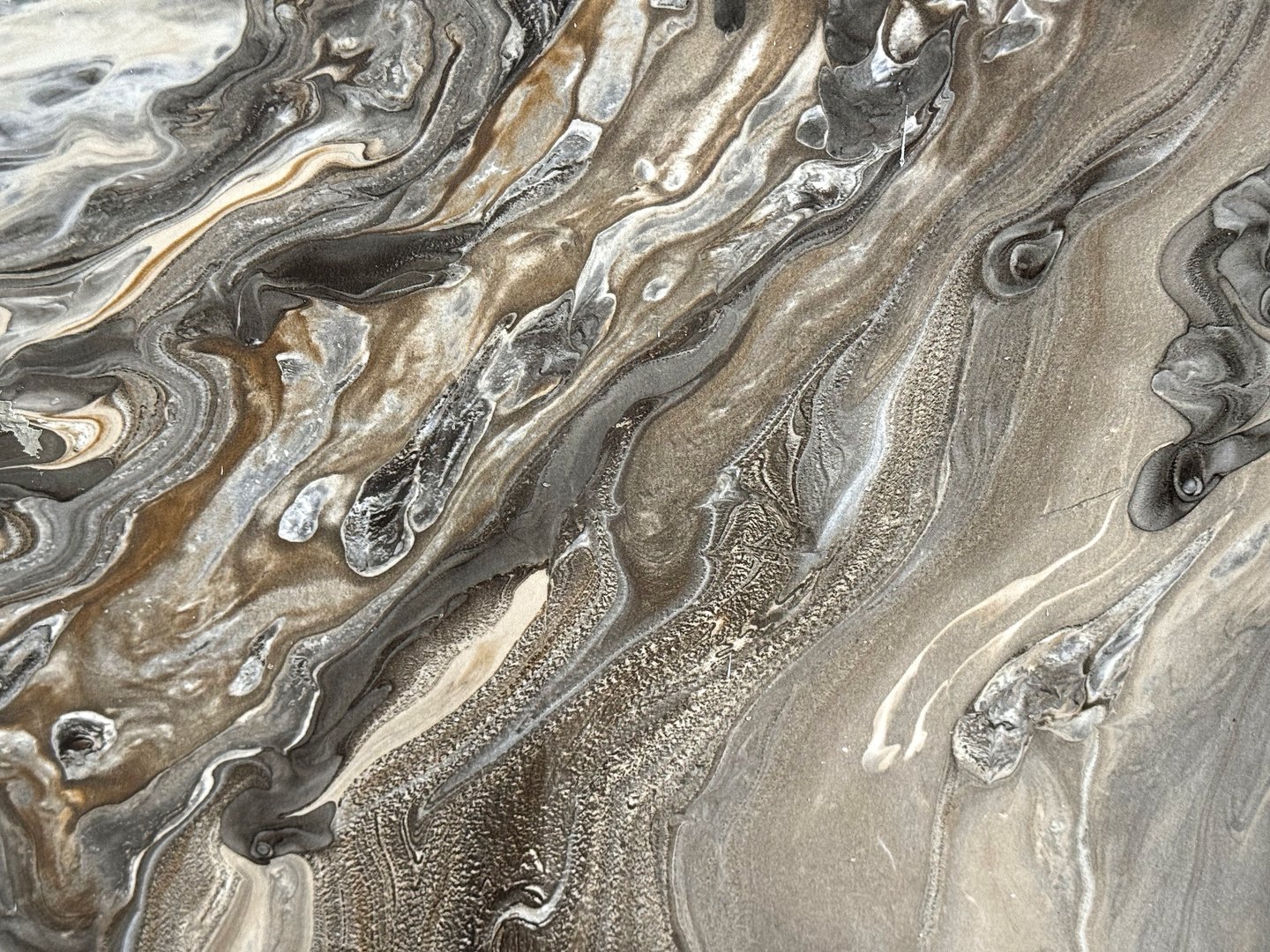 Random exotic earth mud marble with black and white veinings.