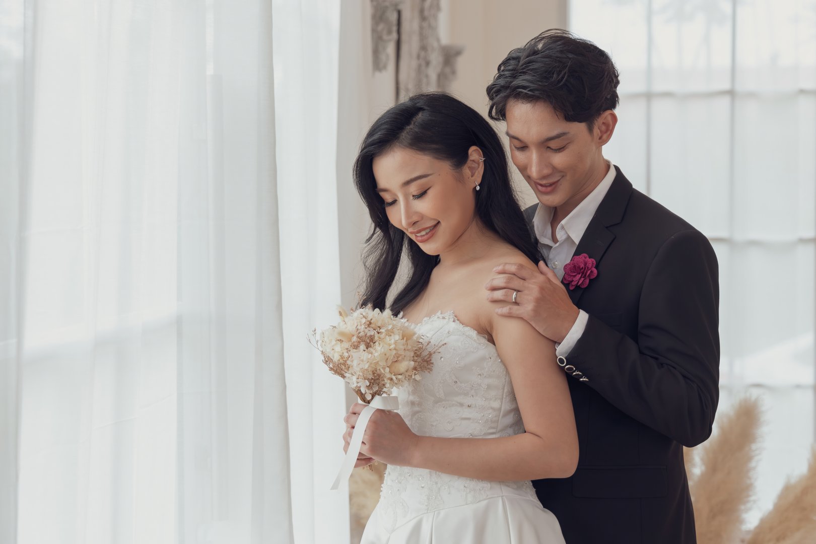 Bride and groom sharing a tender moment, embracing in a beautifully decorated wedding venue.
