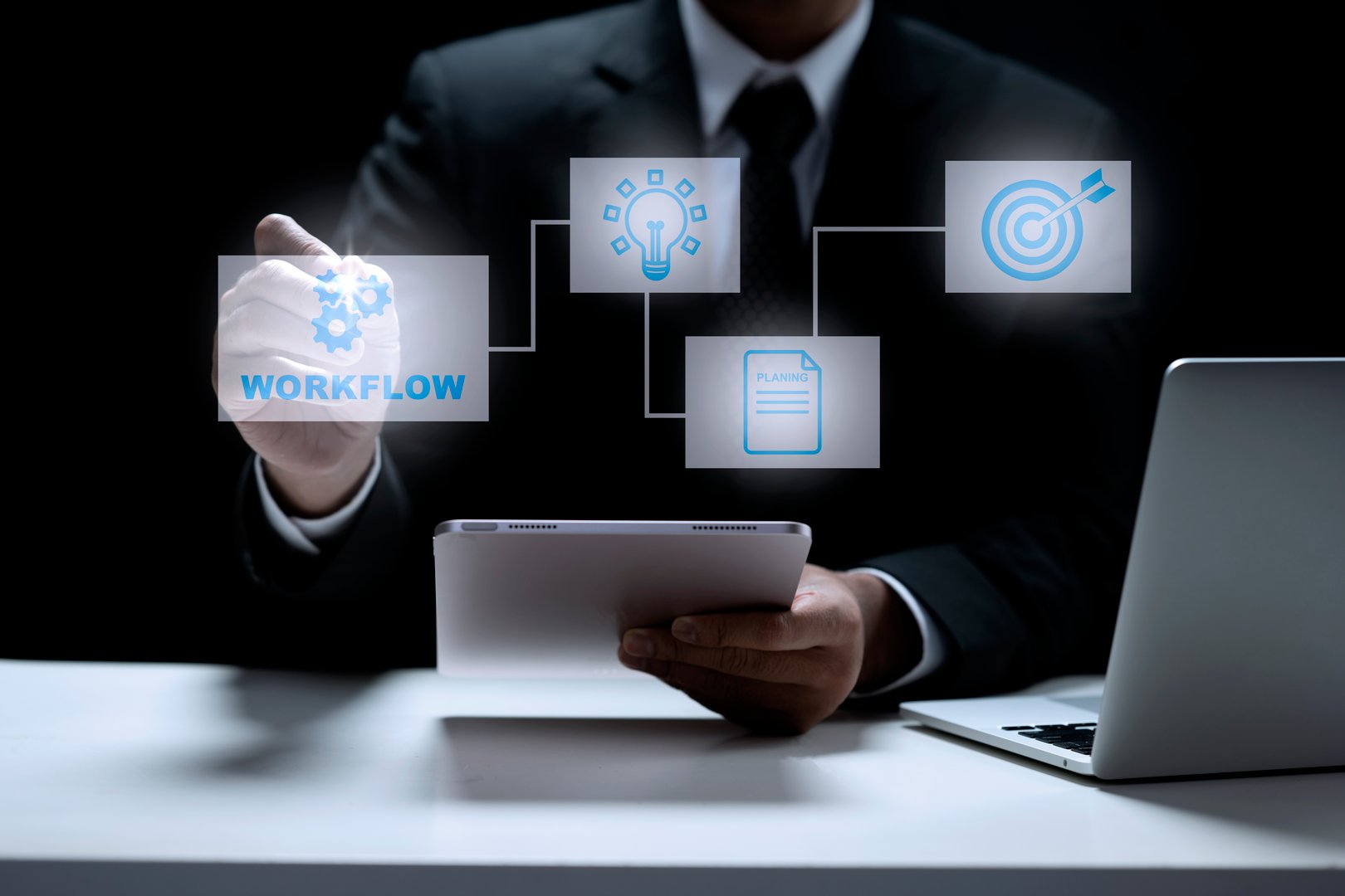 Business person in a dark suit interacts with digital icons representing workflow, idea generation, planning, and goal setting, illustrating a modern business process. Concept of workflow