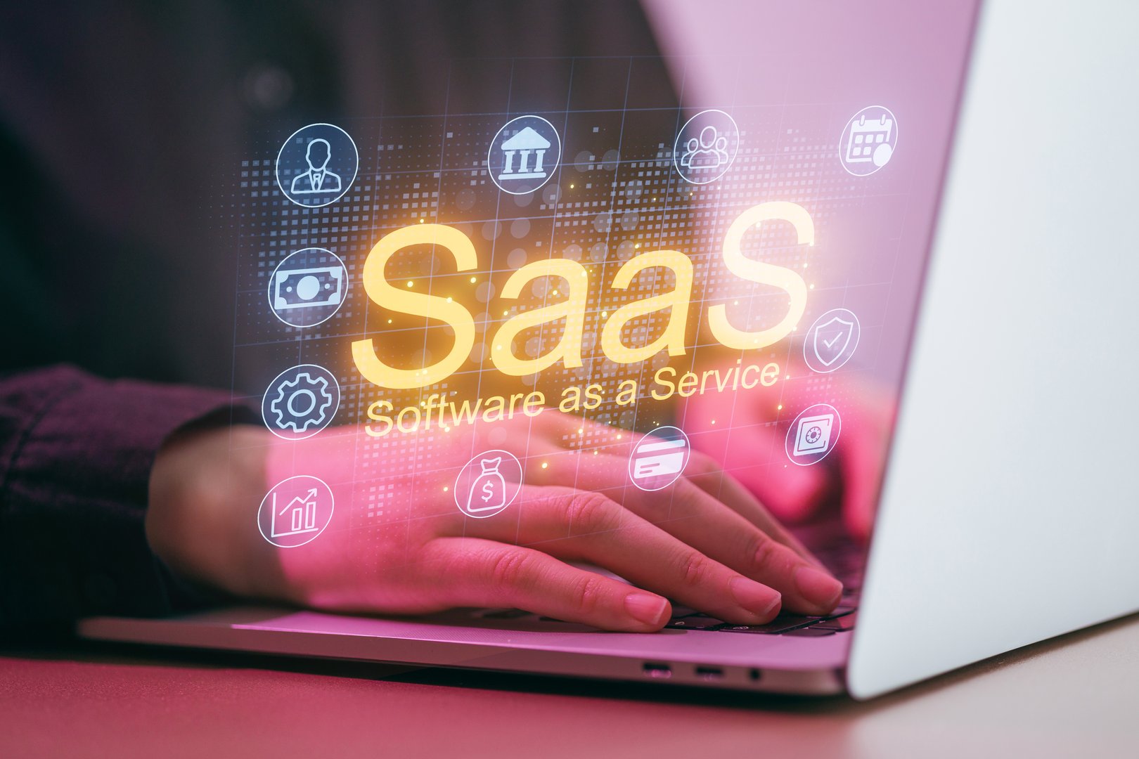 A person is using a laptop at a workspace. Glowing icons around the screen represent various technology services. The scene shows engagement with software solutions.