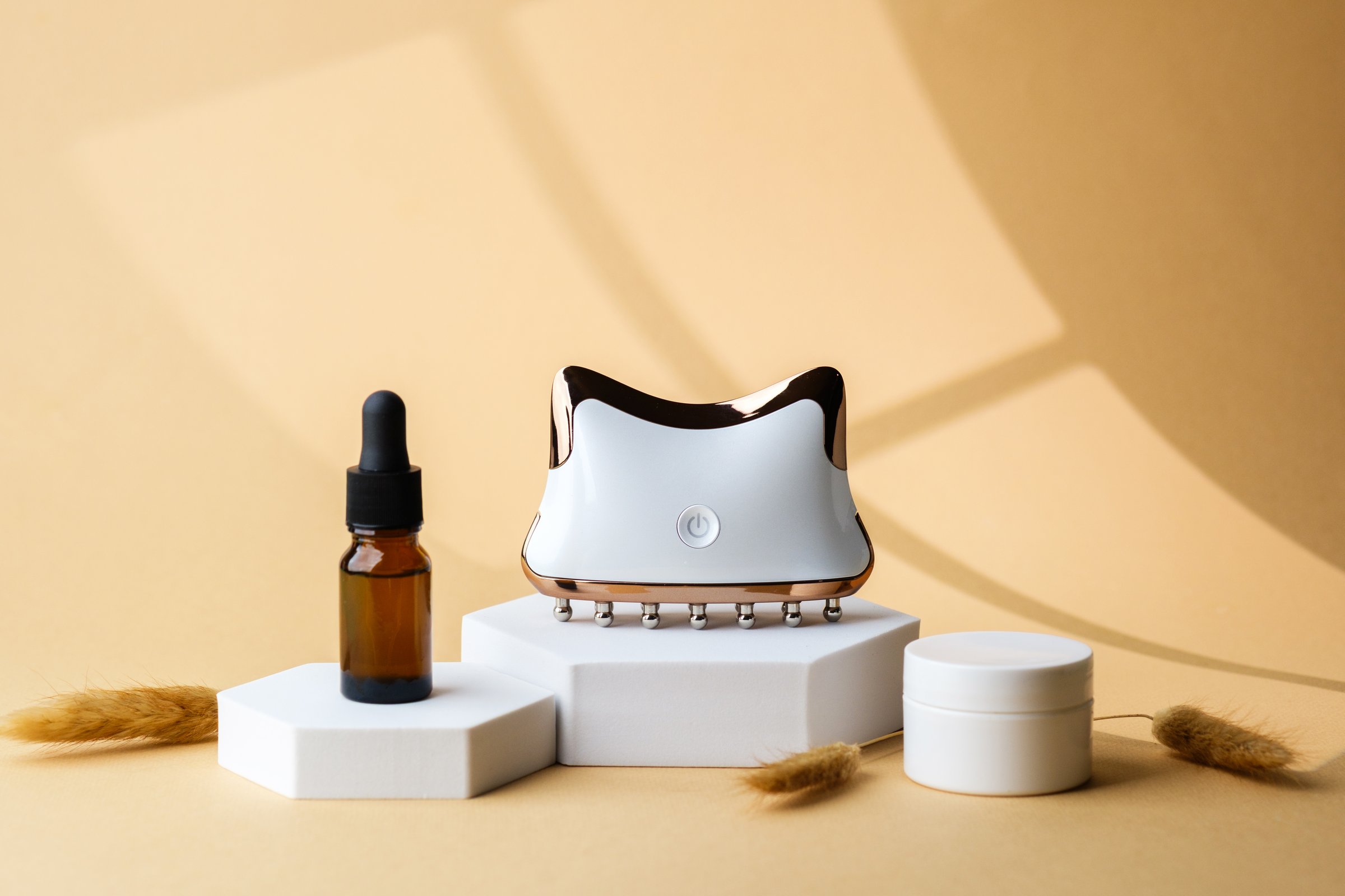 Brown glass dropper bottle with electronic face massager