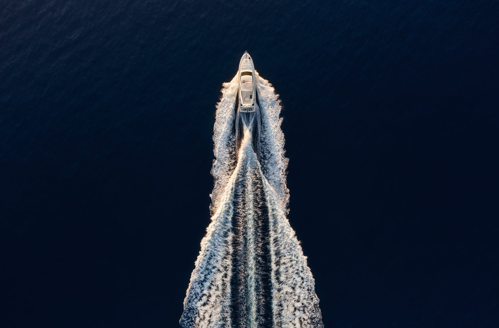 Aerial view on fast boat on blue Mediterranean sea at sunny day. Fast ship on the sea surface. Seascape from the drone. Seascape from air. Travel - image