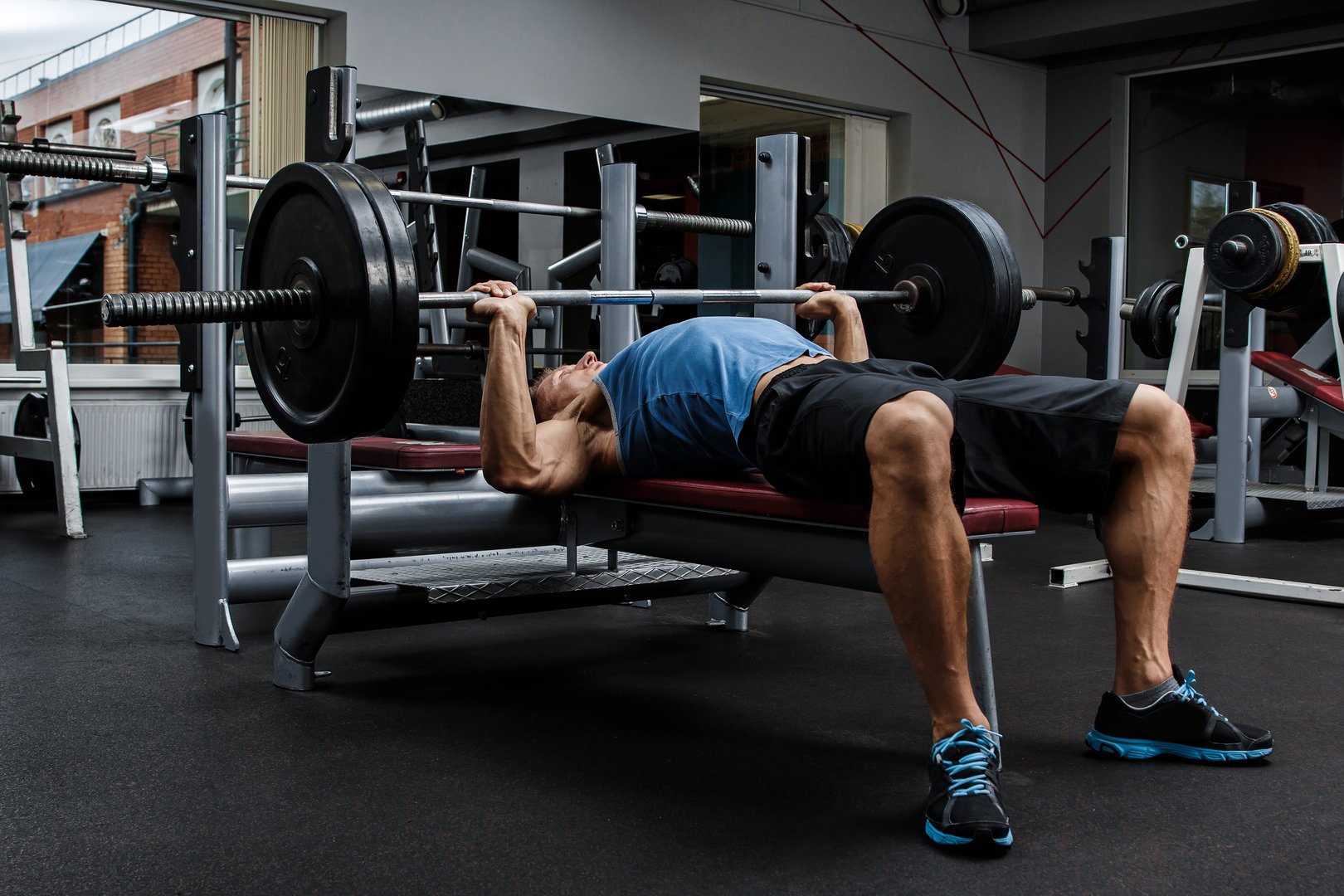Man during bench press exercise in gym