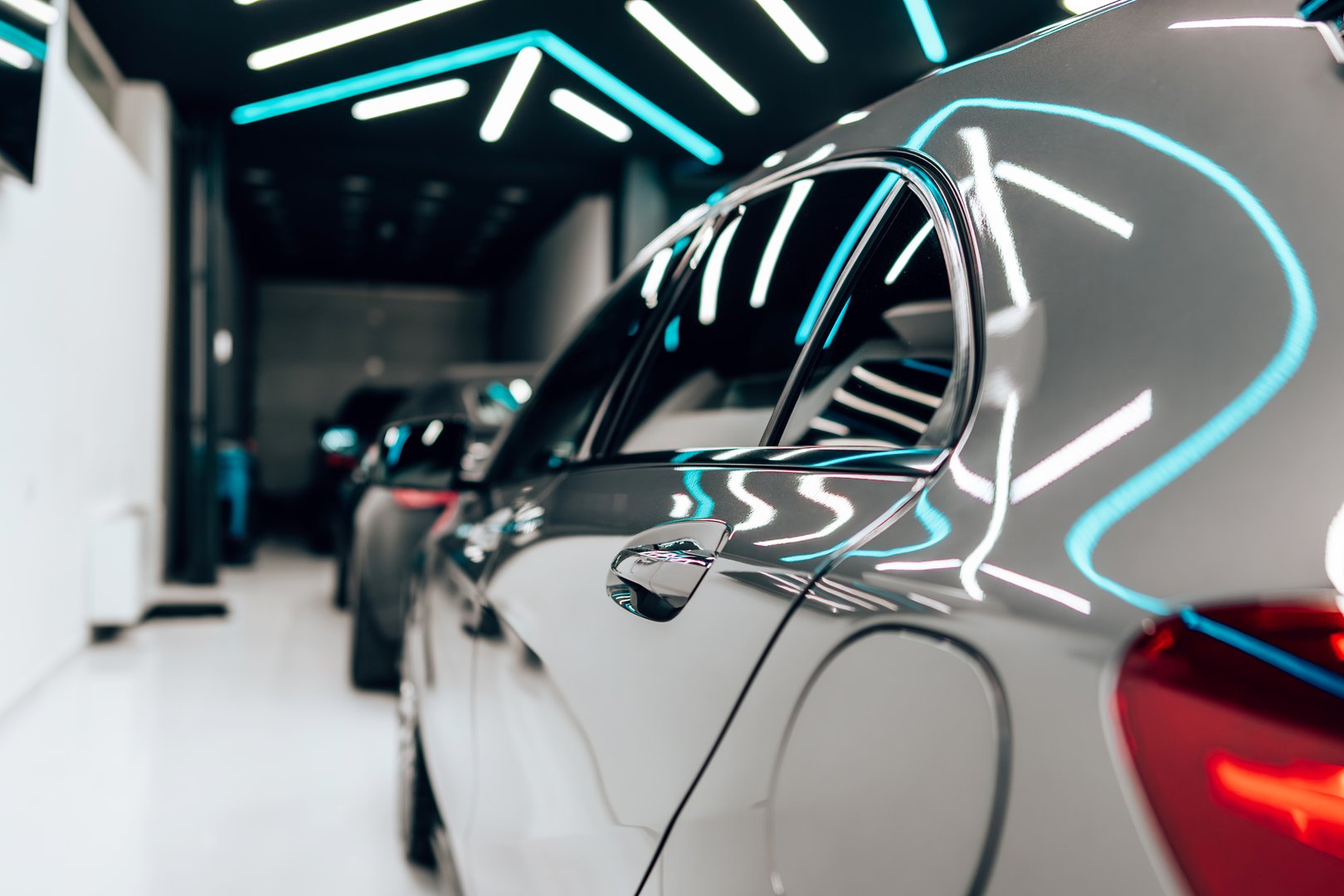 Details from vehicle polishing and detailing service in a modern car workshop.
