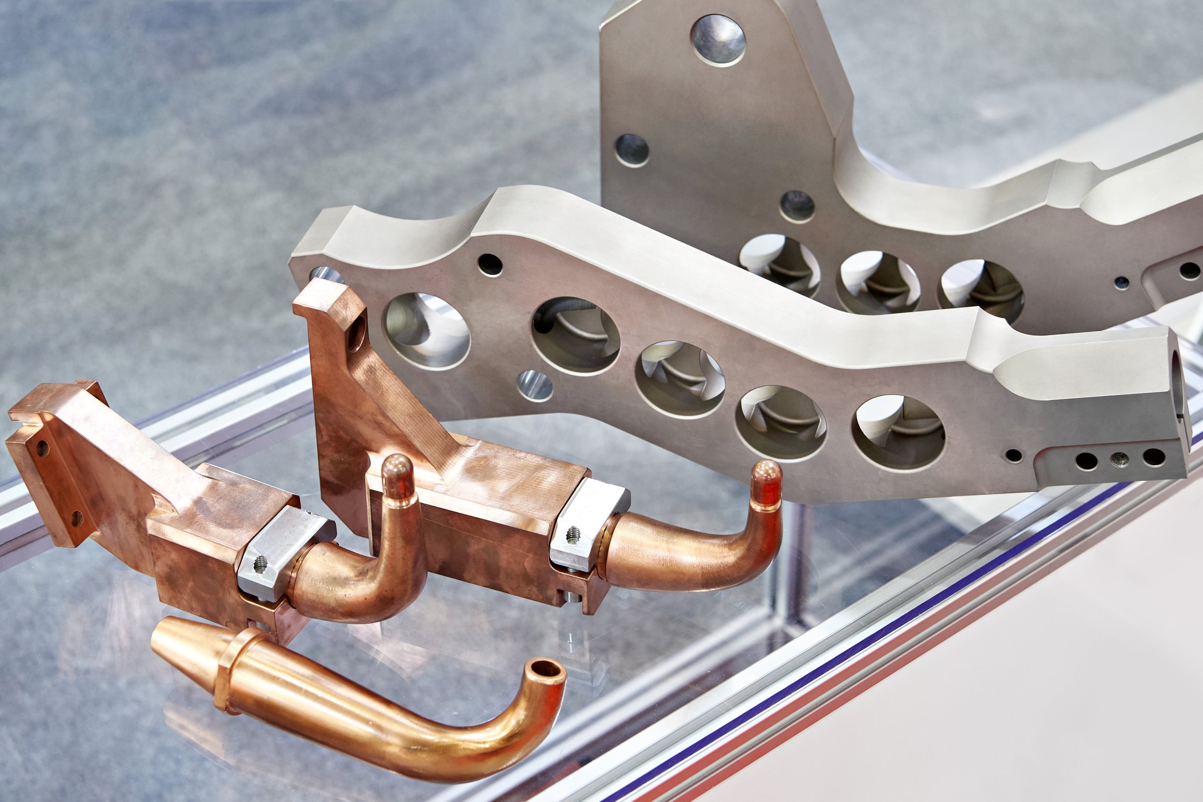 Copper and iron parts for machine tools on glass showcase