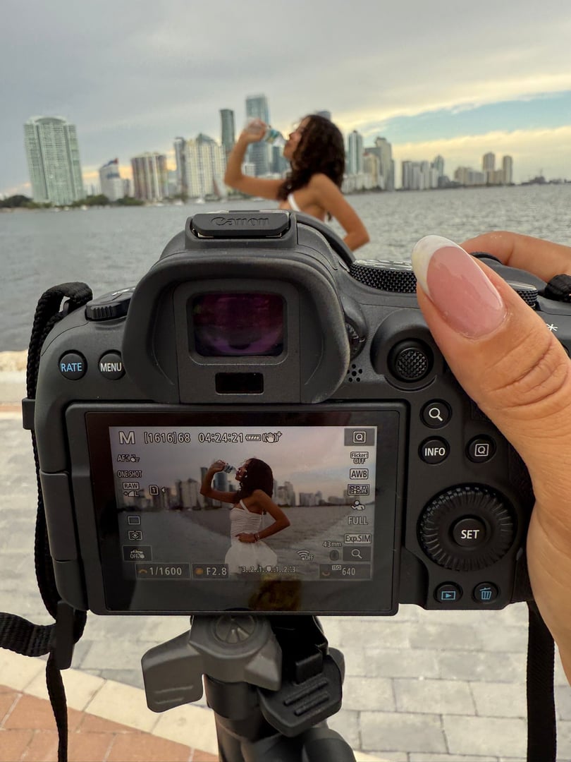 Portrait of female leader standing at corporate firm with arms crossed and smiling at camera.
