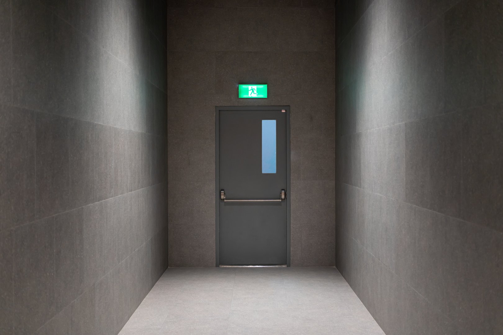 Modern Emergency Exit Door in Dark Hallway