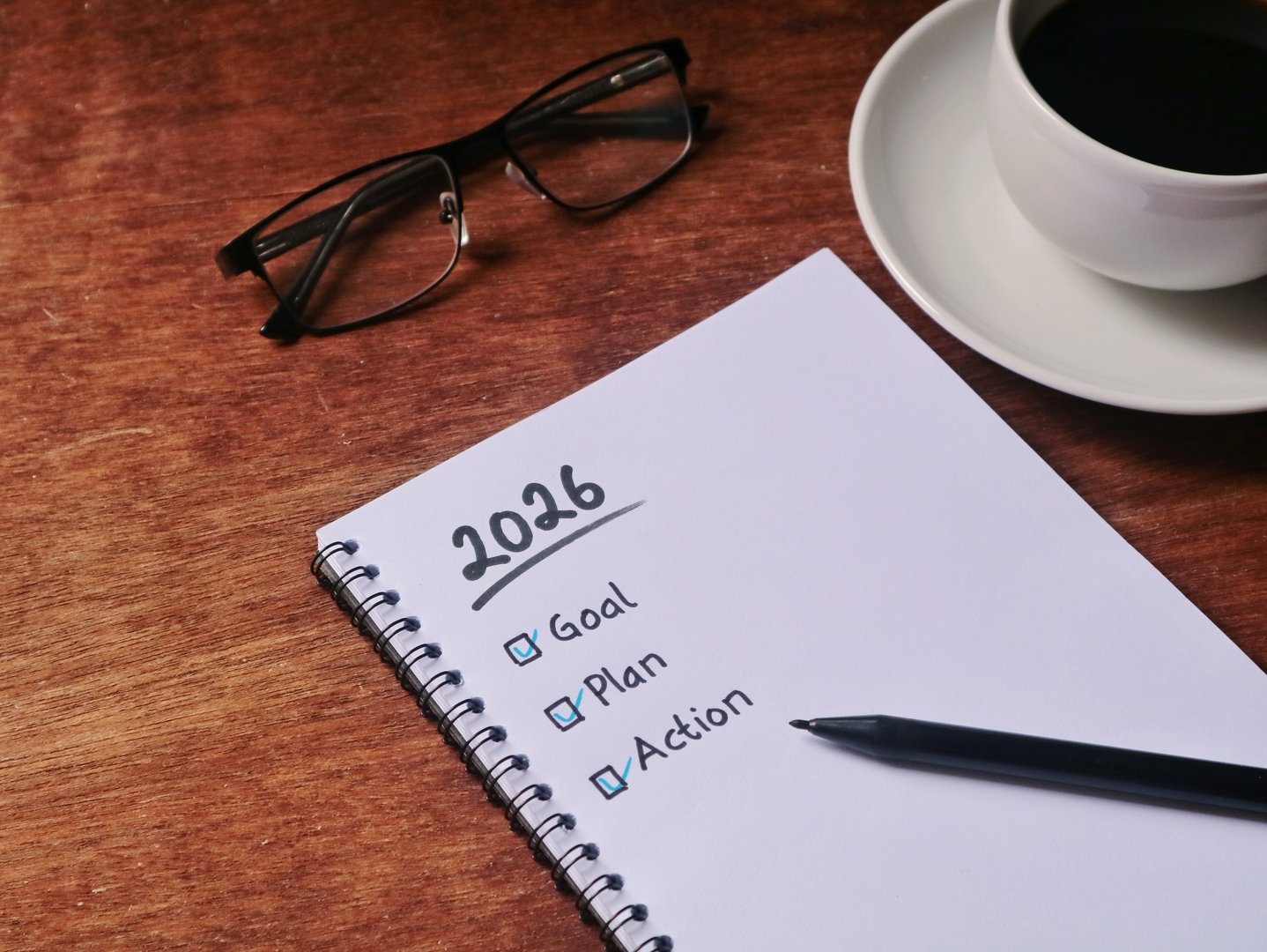 2026 new year resolution concept. Goal, plan and action handwriting on notebook. representing motivation, productivity, and future resolution