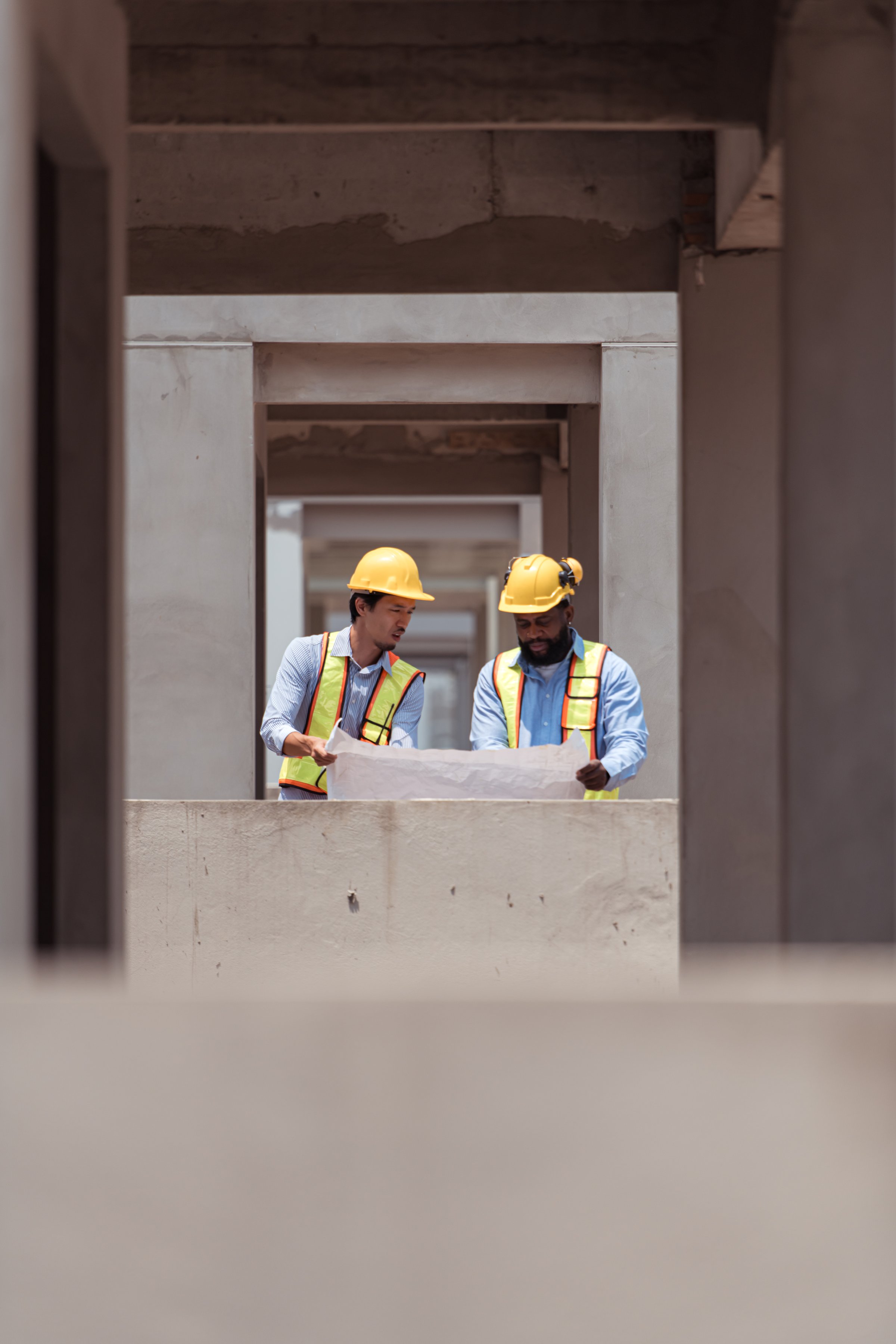 Architects and engineers work together to assess the residential home construction site's progress