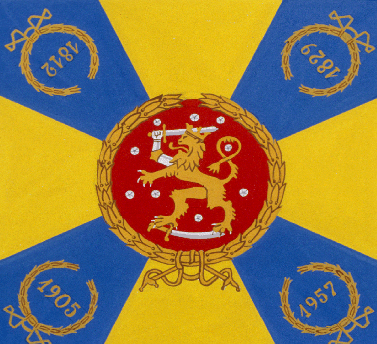 A flag with a lion emblem in a red circle, surrounded by blue and yellow sections and dated wreaths: 1812, 1829, 1905, 1957.