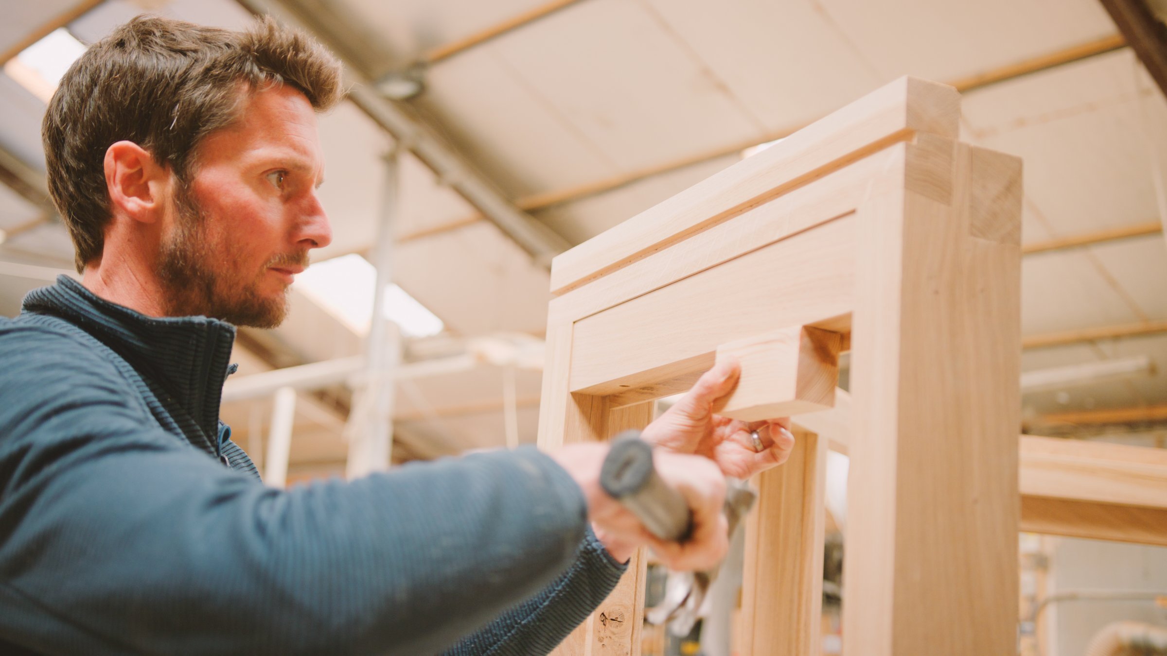 Close Up Of Carpenter In Workshop Building Wooden Window Frame