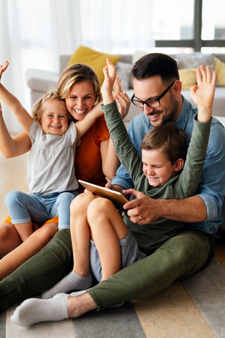 Digital device technology family online education concept. Happy young family with digital devices at home.